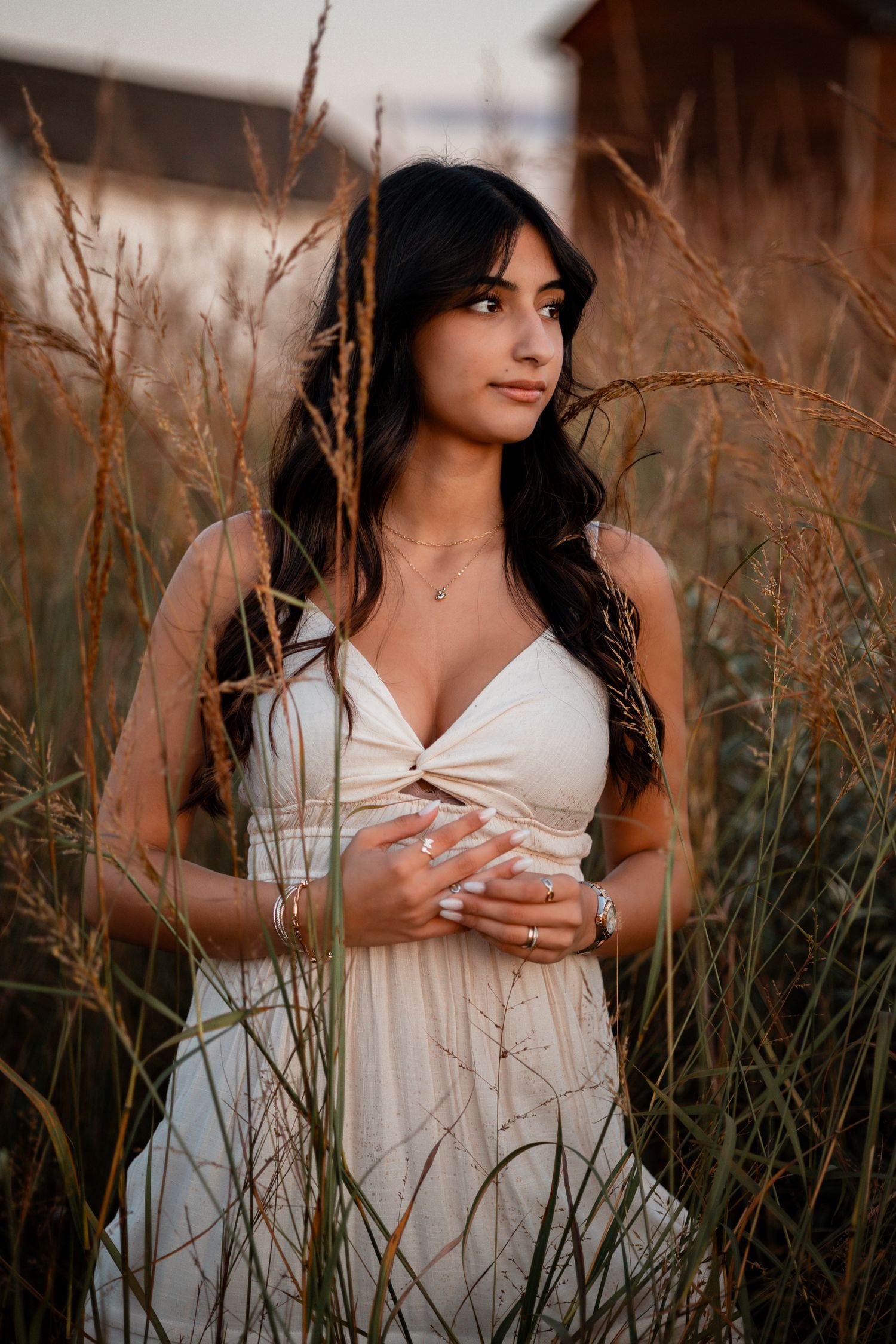 White summer dress among swaying tall grass during late afternoon golden hour.