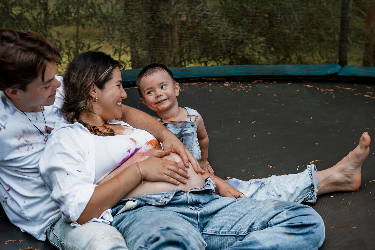 Close up view of young siblings sitting together on a bench and sharing a heartfelt hug.