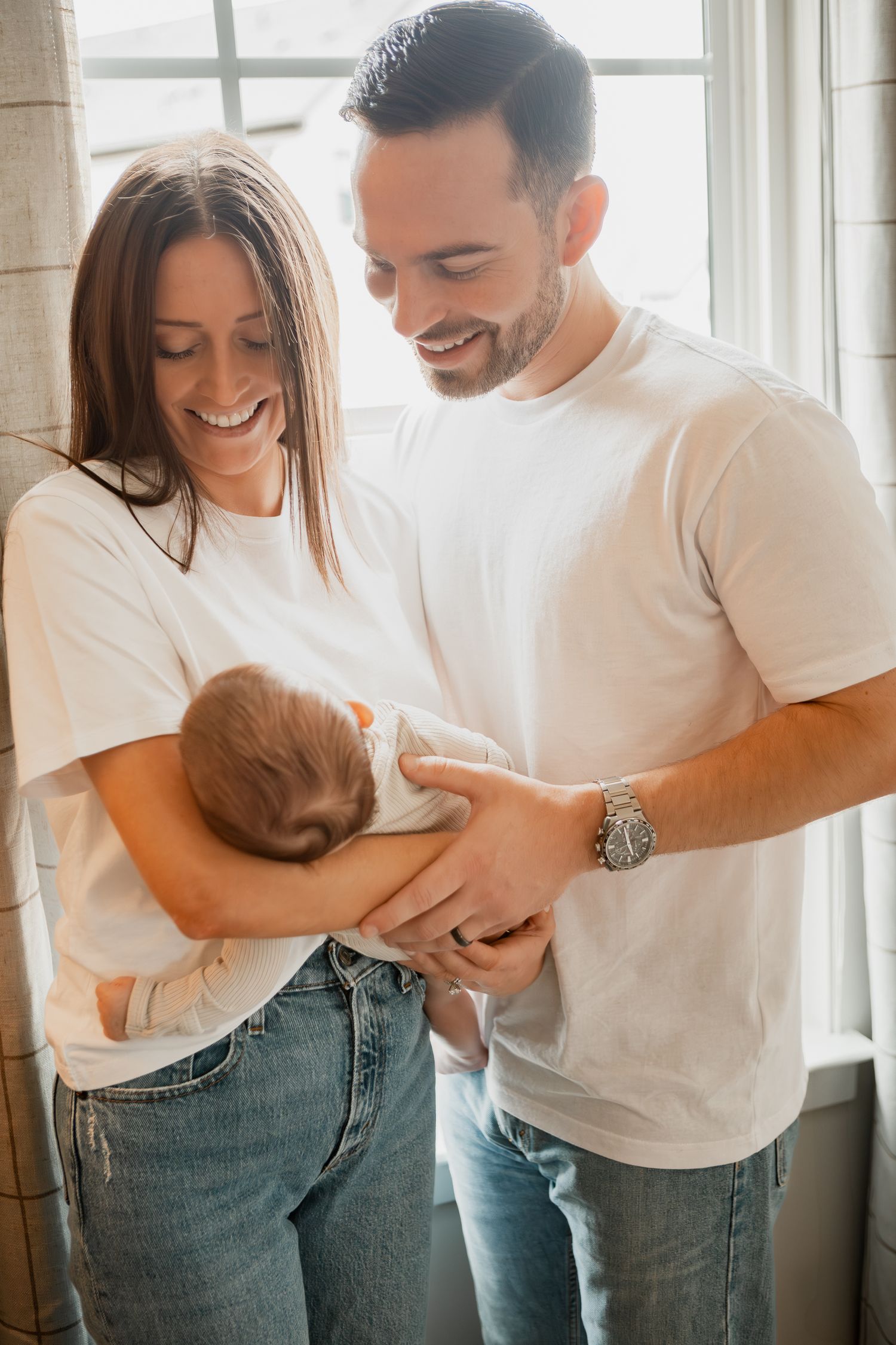 Candid family moments captured in sequence showing joyful interactions next to large window with natural light.