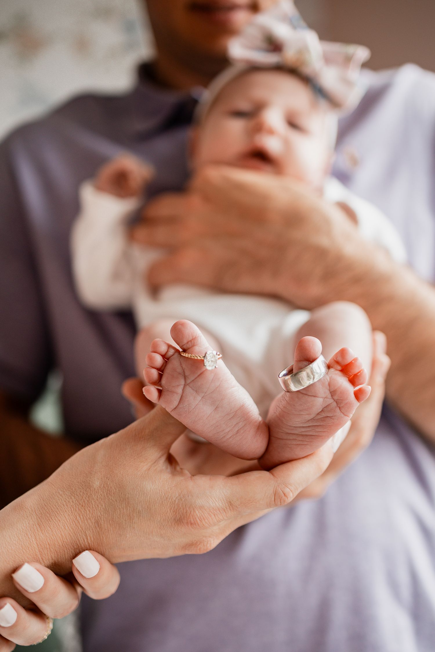 Close-up series of tiny newborn feet being gently held in adult hands.