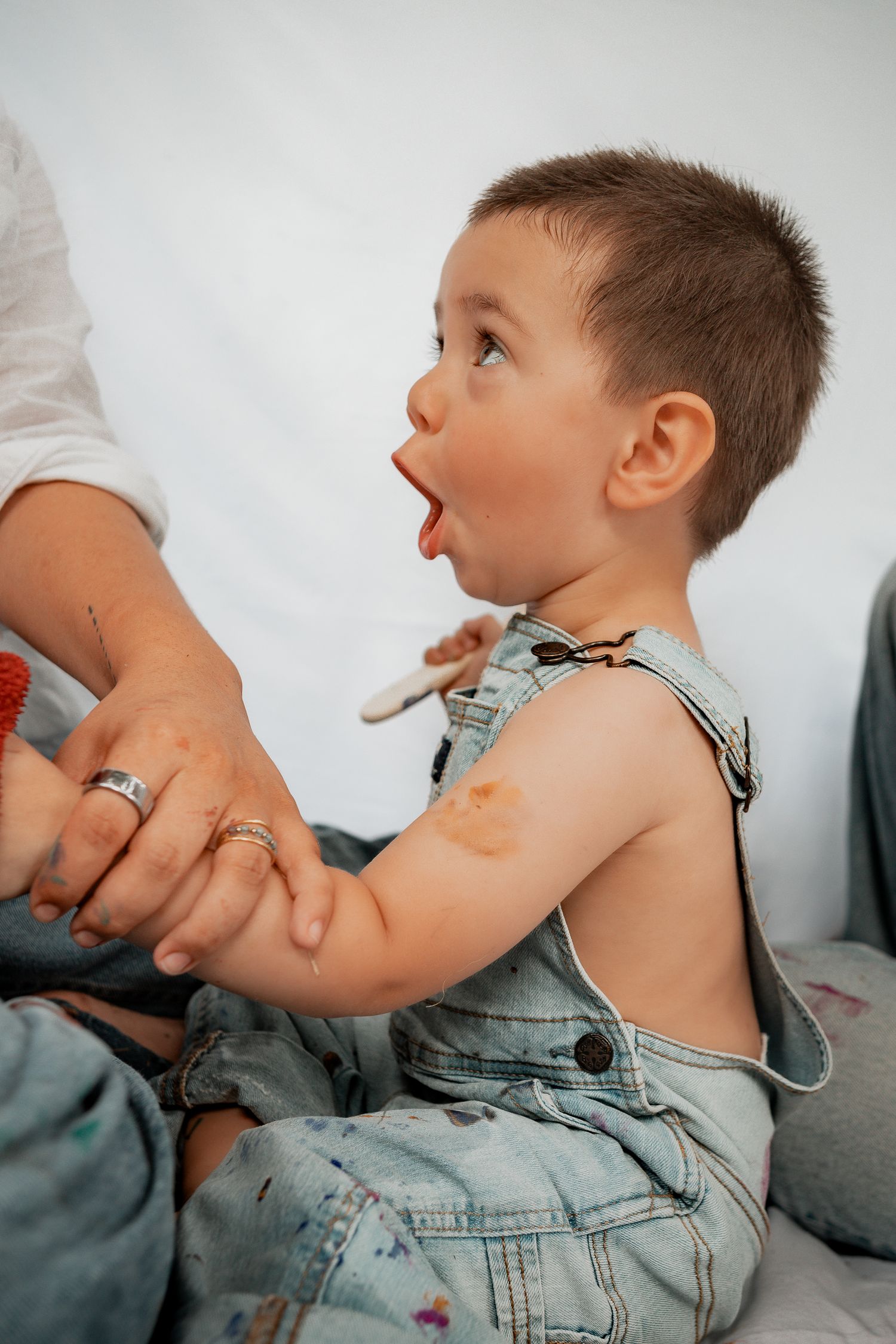 Creative photo series shows gentle medical examination with stethoscope in white medical setting.