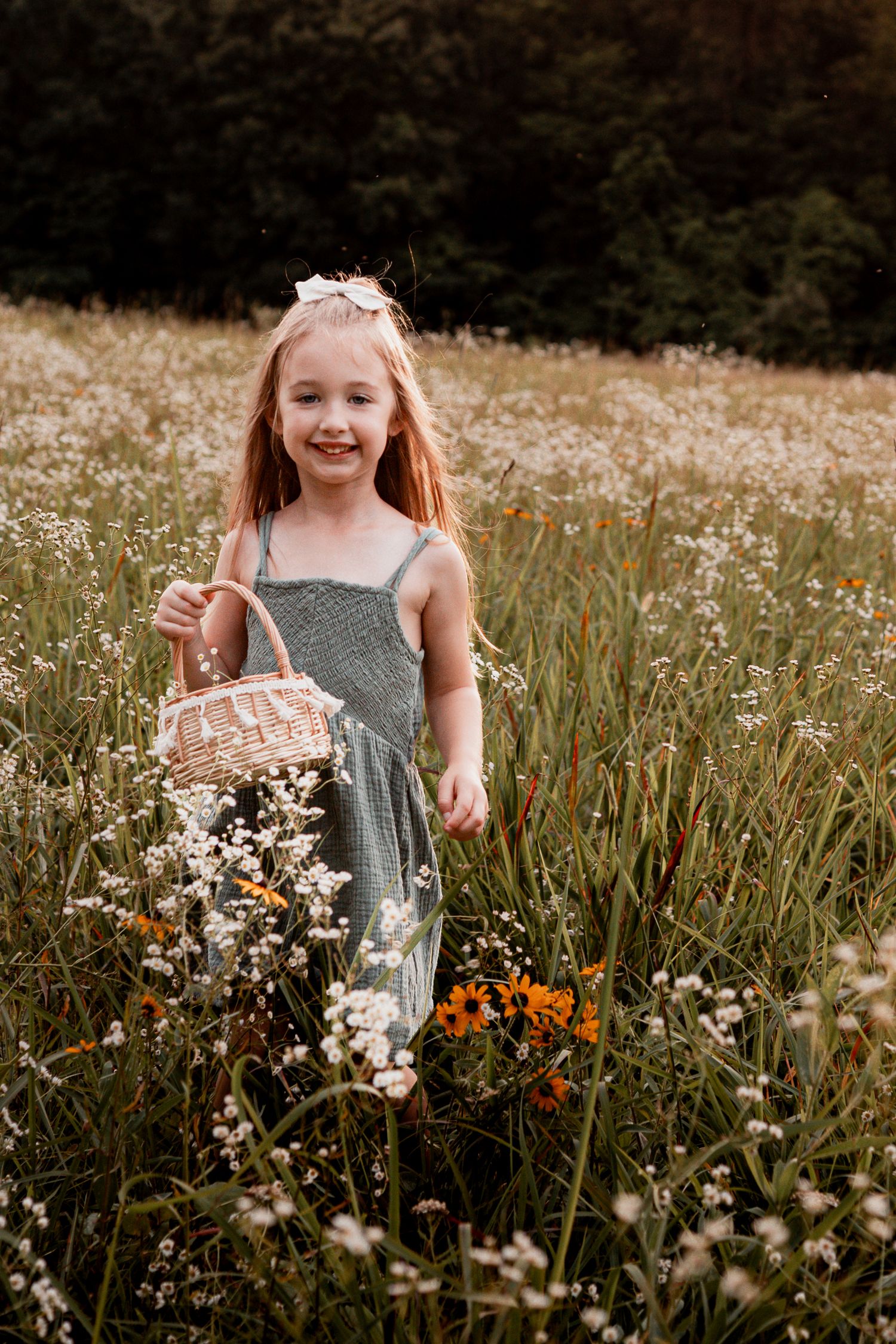 A joyful moment captured in a summer meadow filled with orange and white wildflowers.