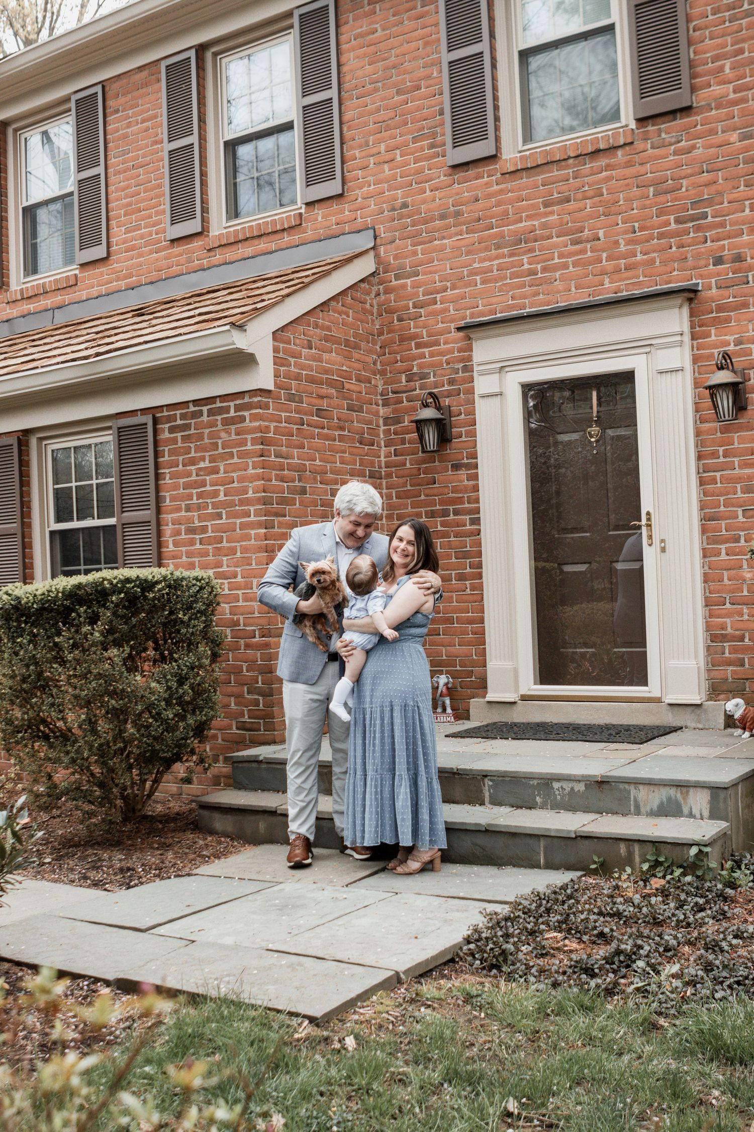 A series of tender moments on the steps of a brick row house property.