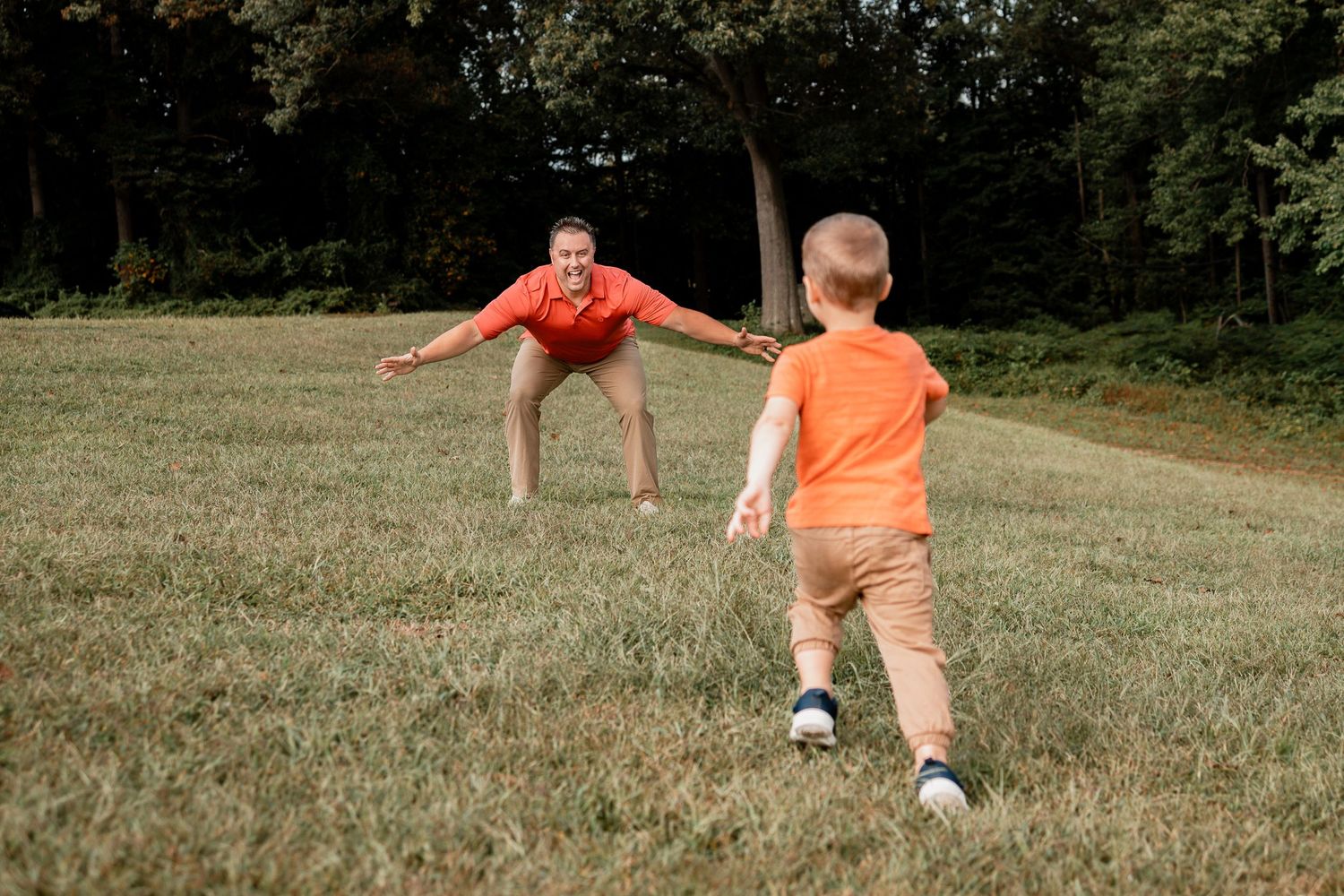 A sequence of action shots shows a person in an orange shirt performing a back handspring on a grassy hill.