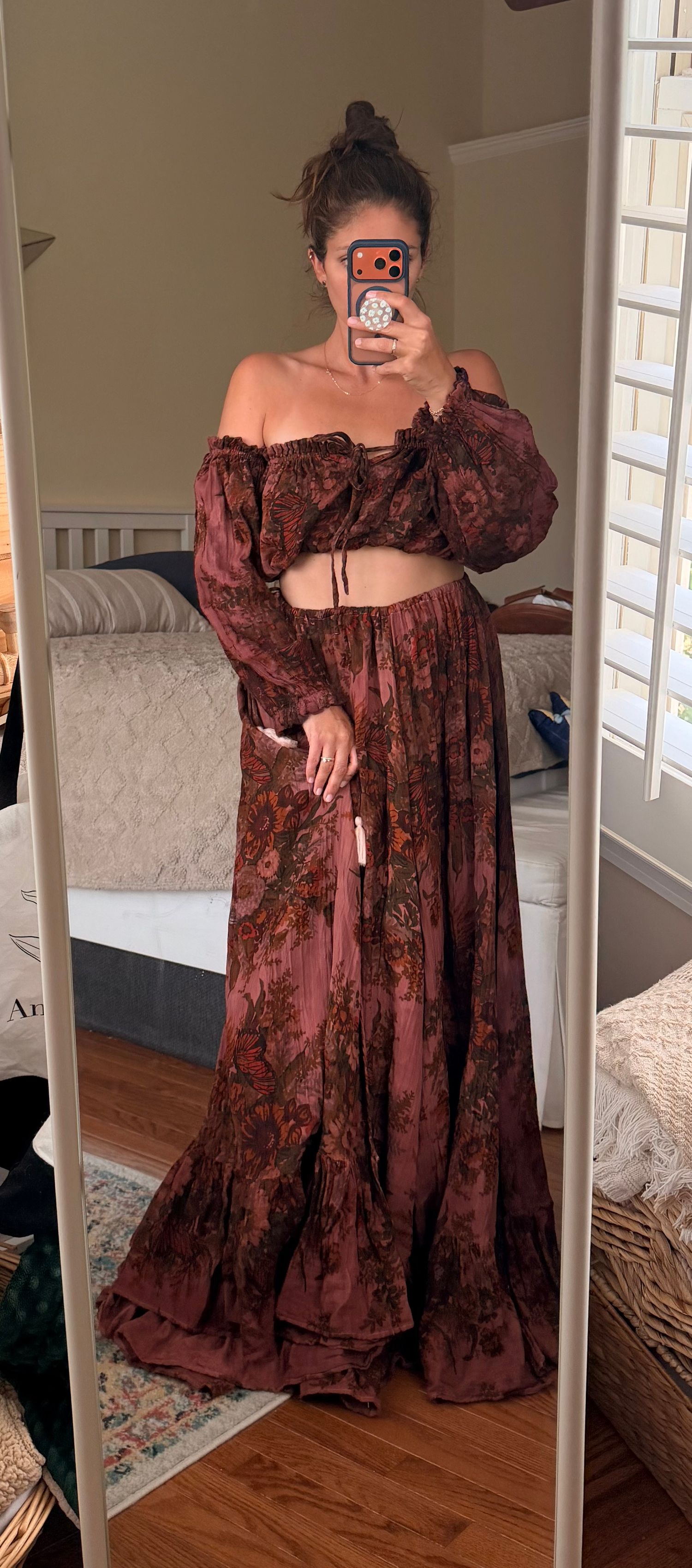 Woman wearing a boho floral rust maxi skirt and matching off-shoulder crop top set, mirror selfie.