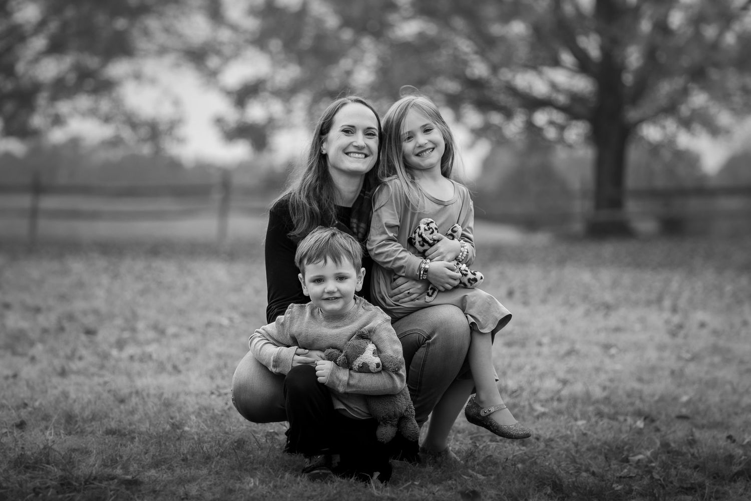 A black and white collage of candid family photos showing joyful moments together outdoors.