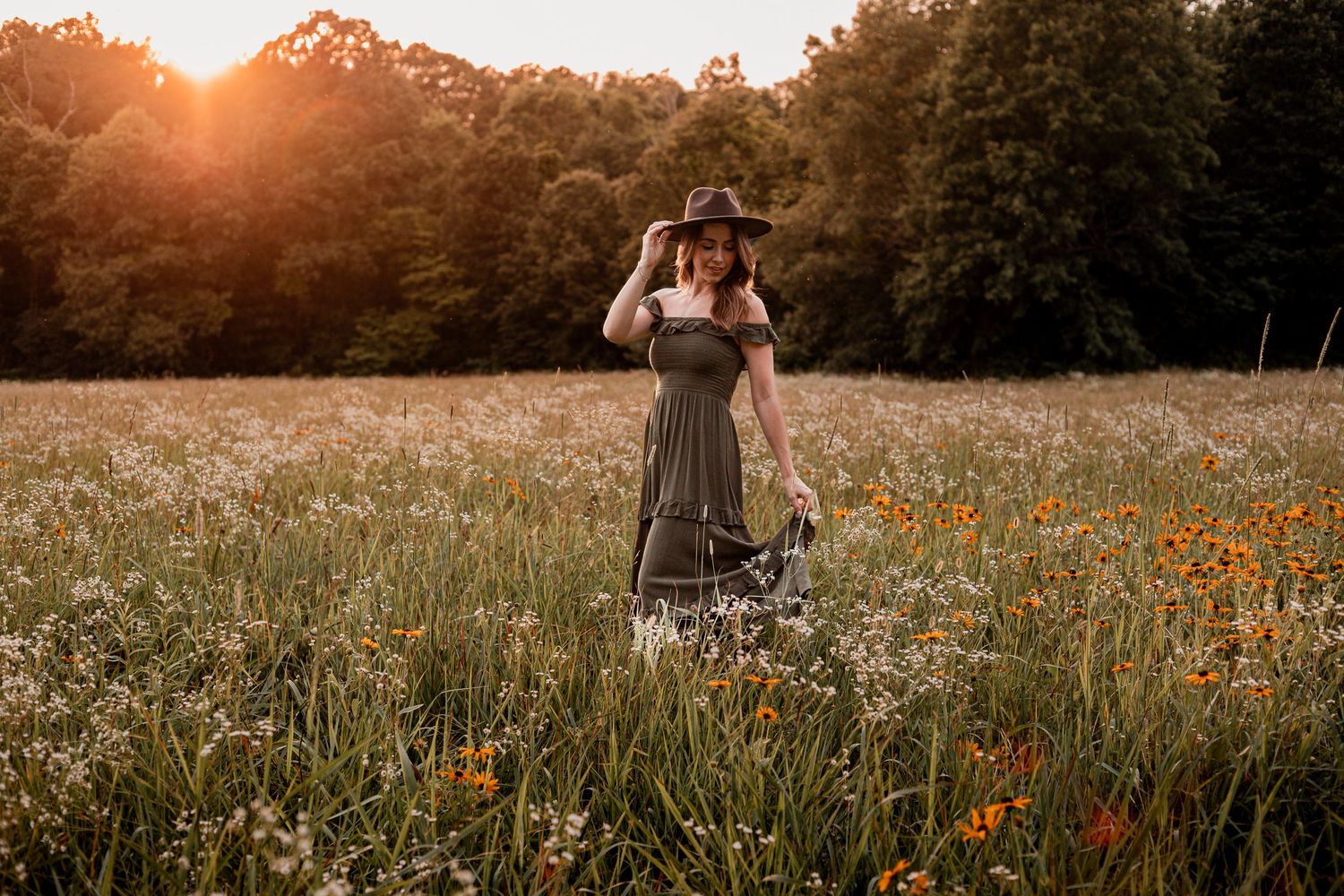 Seven sequential views of a couple walking through a golden meadow of wildflowers at sunset.