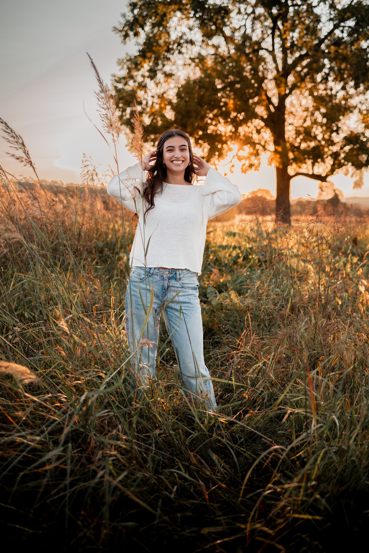 A series of sunset portraits in tall grass with golden light filtering through trees creating a dreamy summer atmosphere.