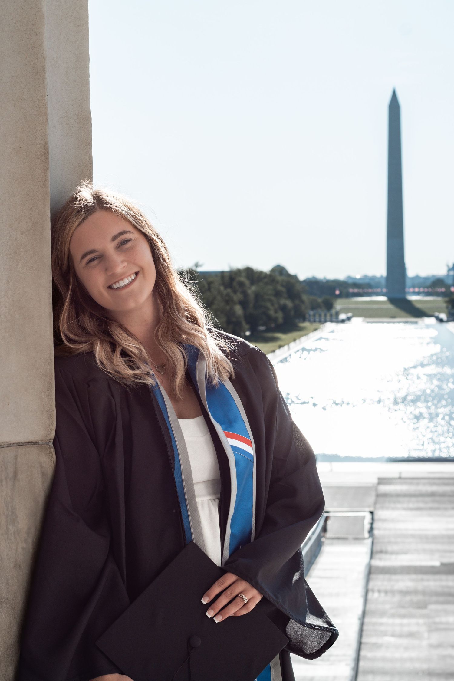 Sunny graduation photos captured at the National Mall with Washington Monument and memorials in view.