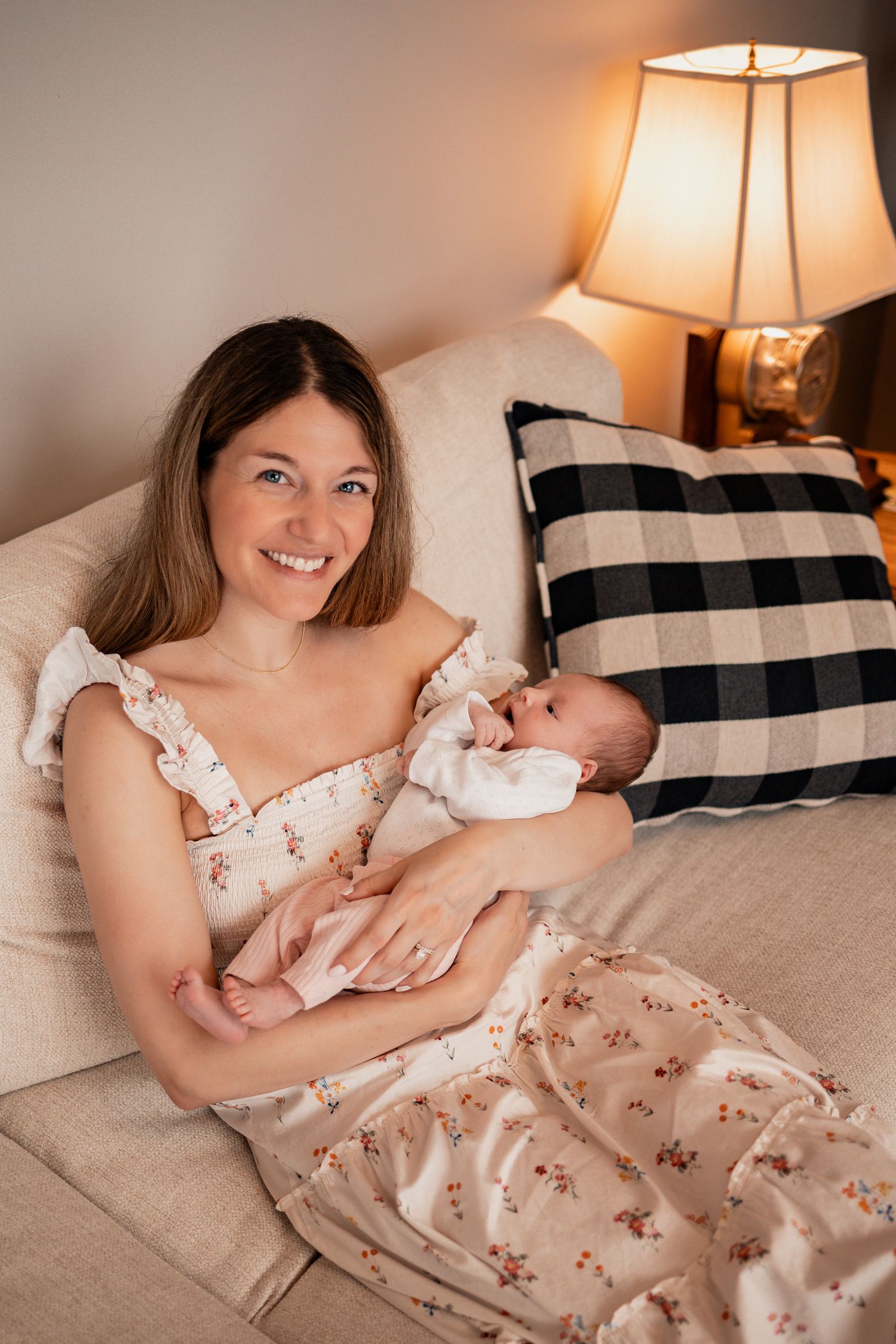 A series of lifestyle photos showing tender moments between parent and baby on a bed with buffalo check pillows.