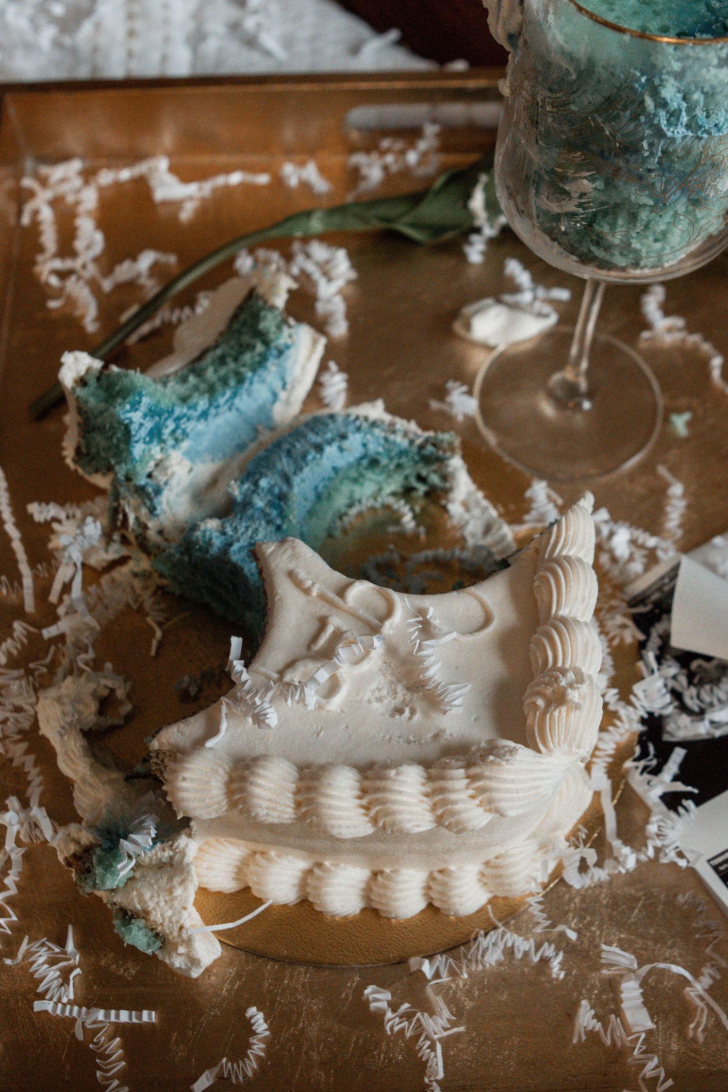 White plaster dental molds and castings being made with blue-green equipment on a dusty work surface.
