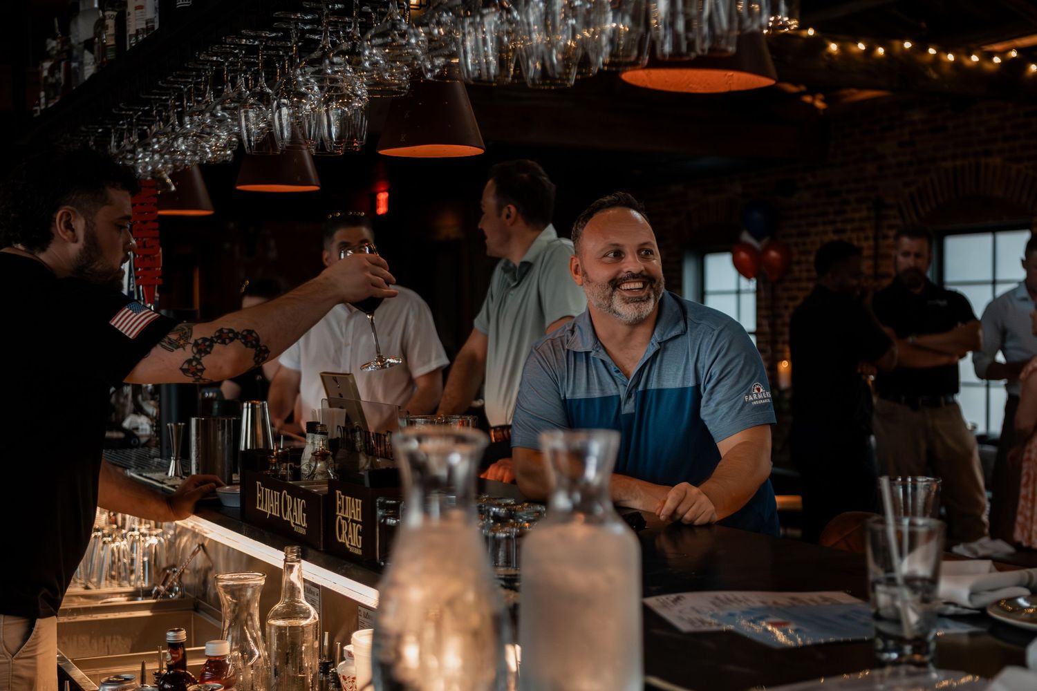 Dark ambiance of a restaurant bar with string lights creating a warm atmosphere.