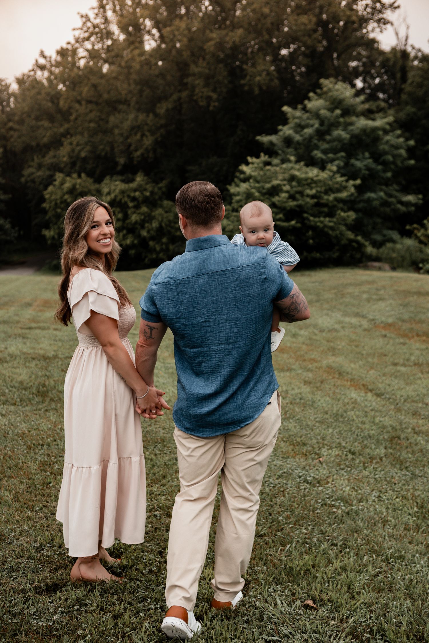 Multiple images show a sweet moment of a couple walking with a small child in a grassy outdoor setting.
