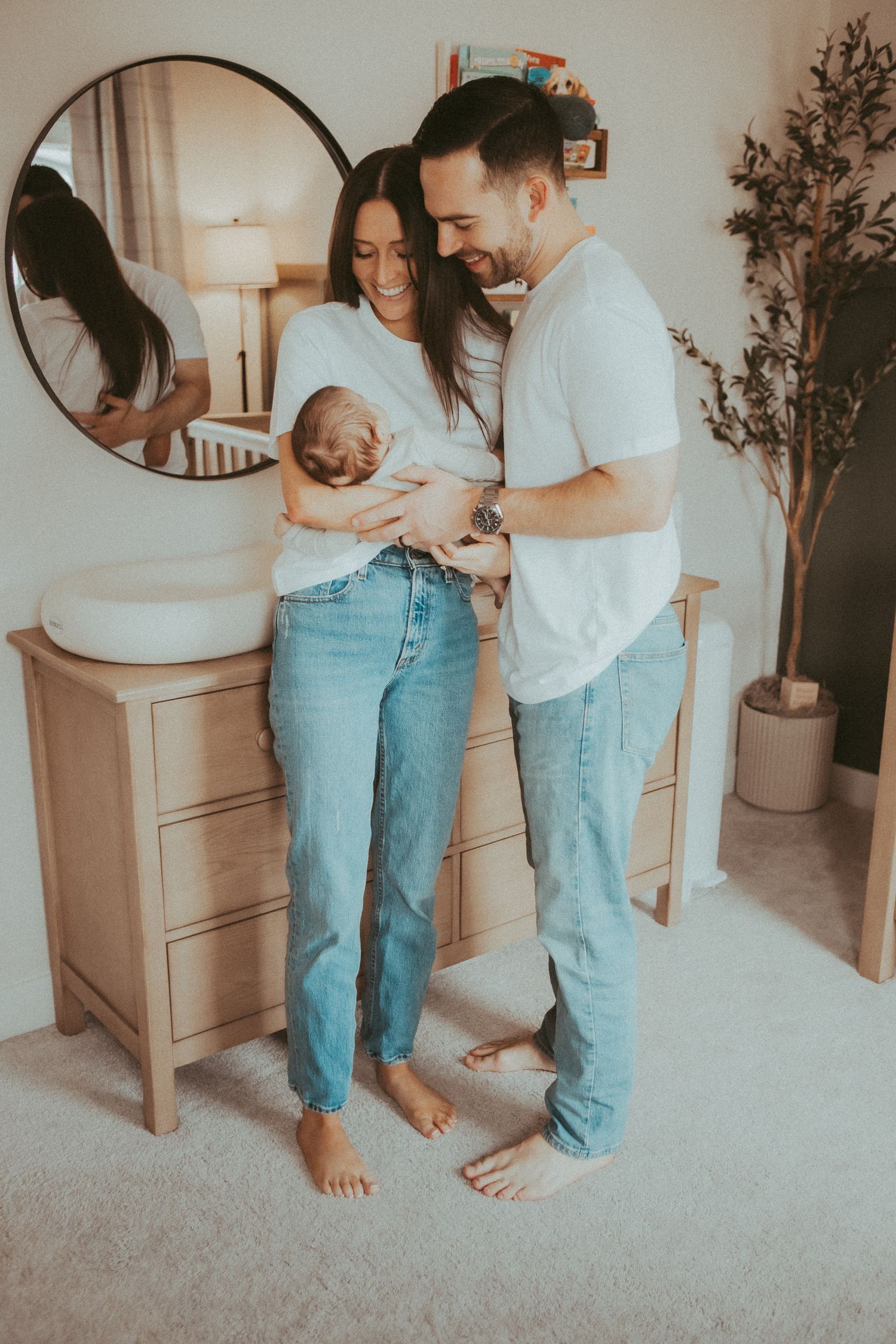 Intimate lifestyle photography series showing a couple embracing in casual attire against a neutral home interior setting.