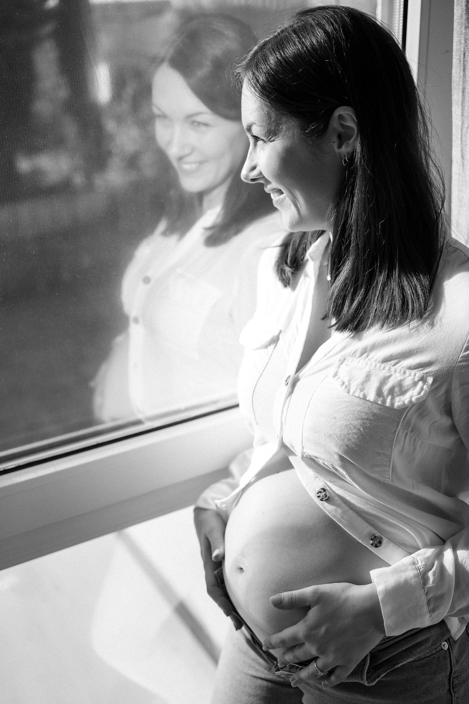 A series of black and white photos showing a woman in white sitting by a window in contemplative poses.