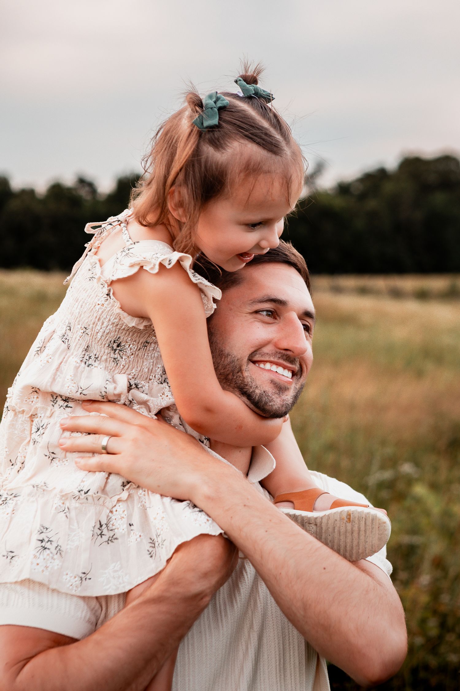 Playful sequence of family moments showing hugs and laughter in a sunlit field at golden hour.