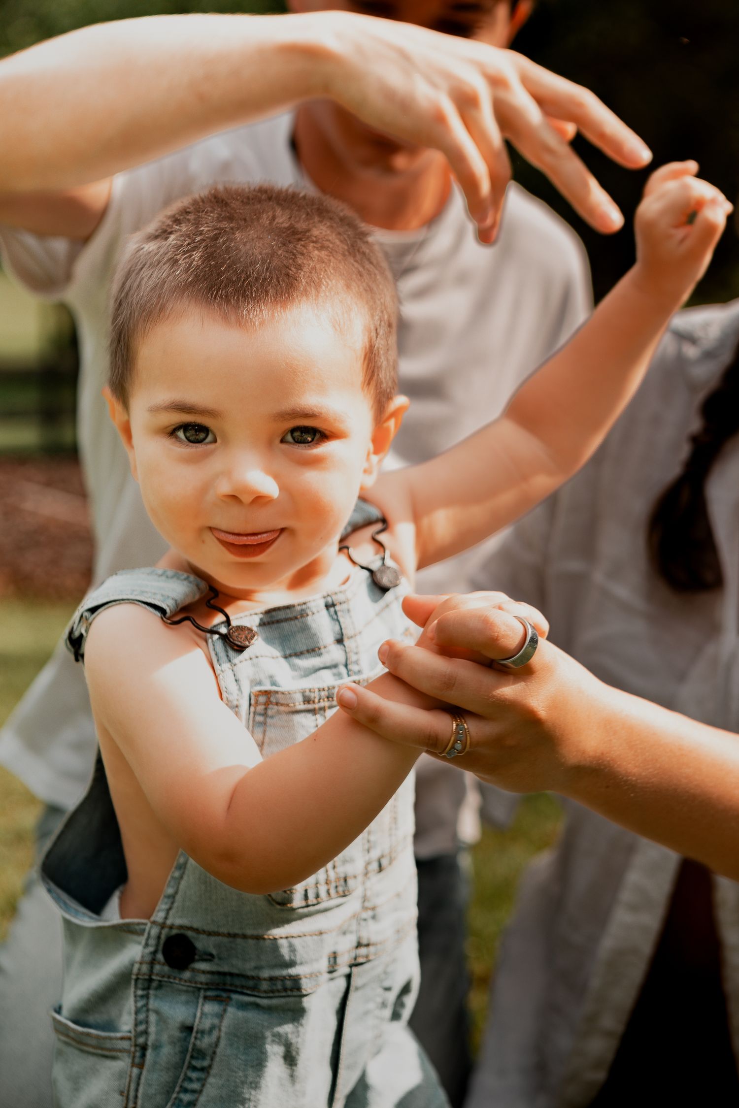 Candid outdoor portraits showing joyful interactions and paint-stained overalls.