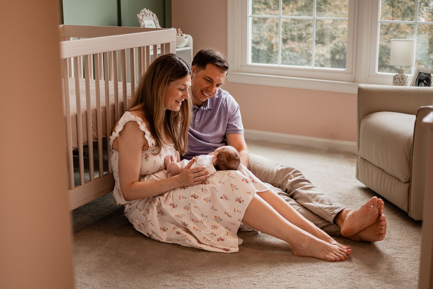 Couple relaxing together in a cozy bedroom with natural light streaming through windows.