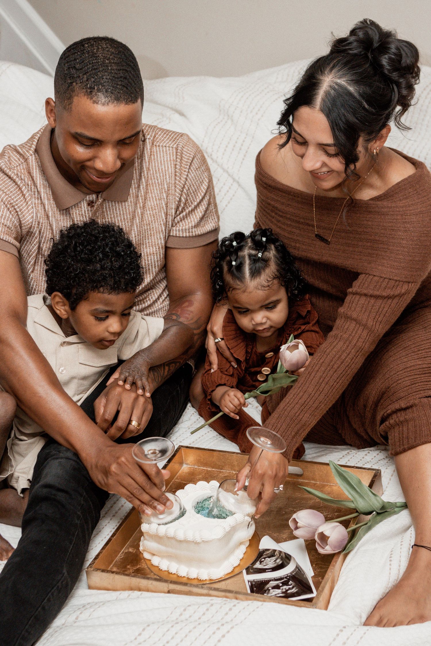 Family bonding together in kitchen as they prepare and shape dough on a wooden cutting board with flour.