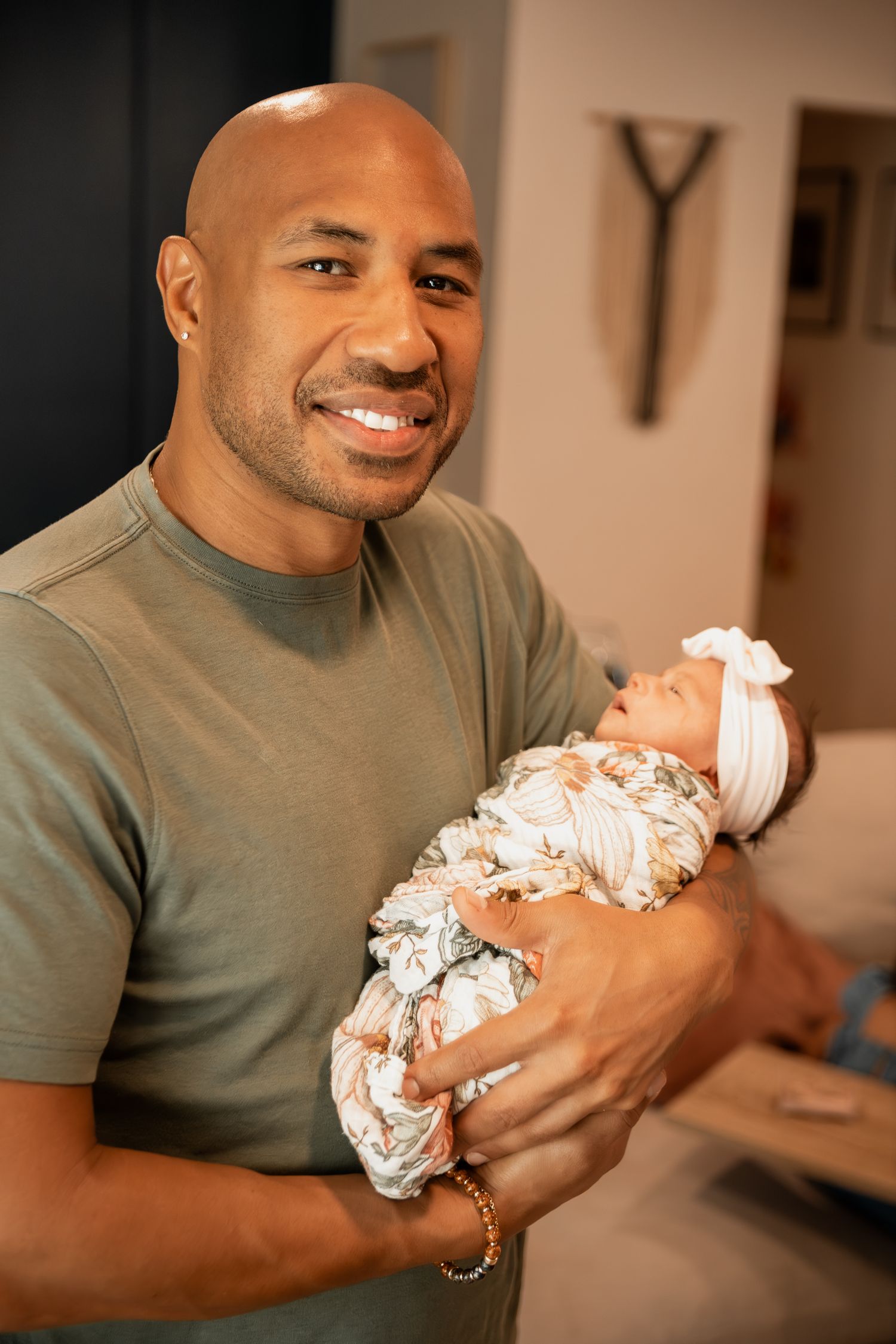 A sequence showing a tender moment between a father holding and gazing adoringly at his swaddled infant.
