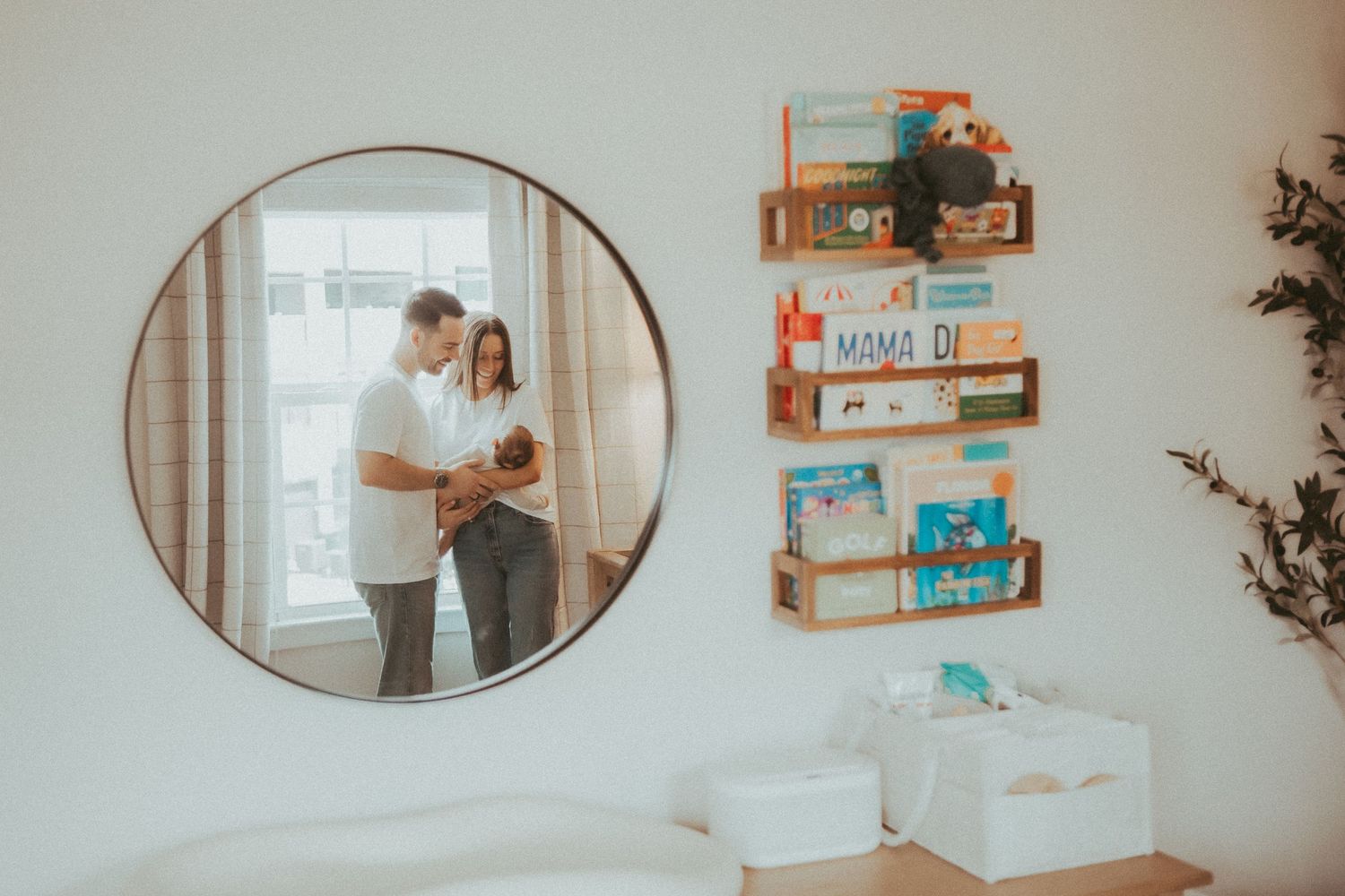 A series of oval mirrors reflect a cozy bedroom interior with bookshelves and natural lighting.