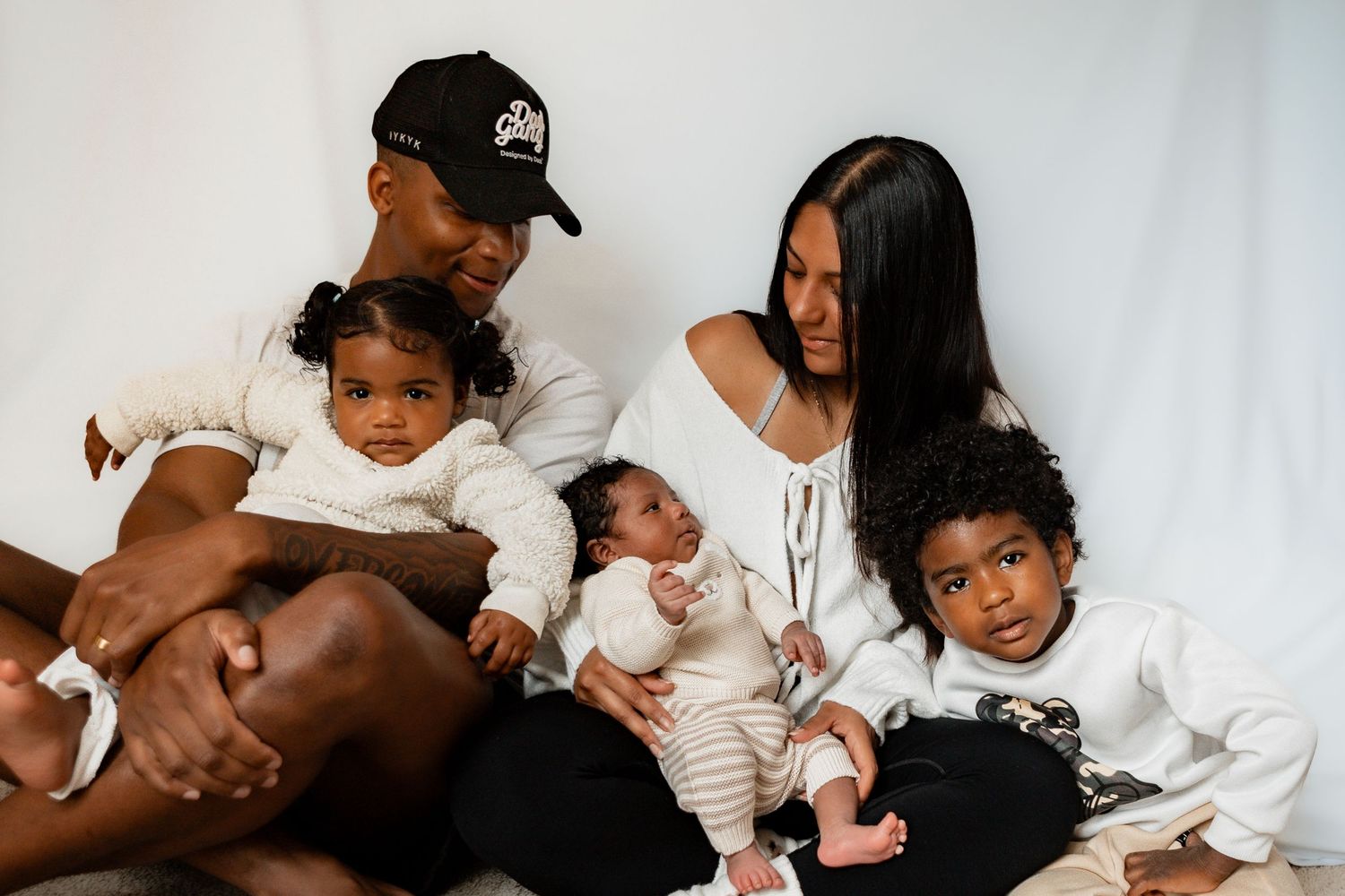 A collage of tender moments showing a baby being cradled and held by loving family members.