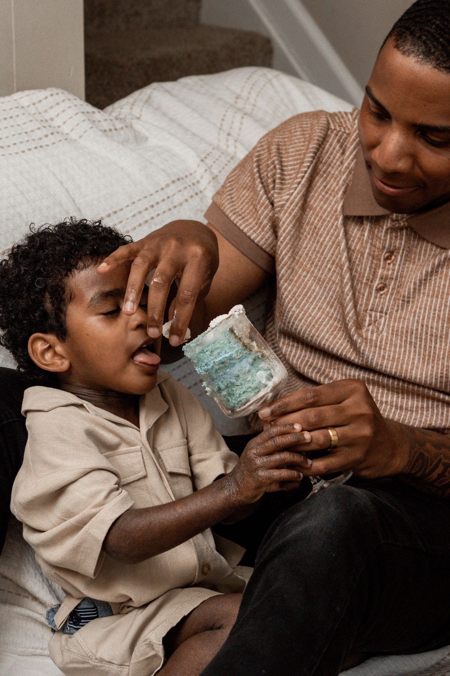 A sequence showing a young child drinking water from a glass, helped by someone in a beige shirt.