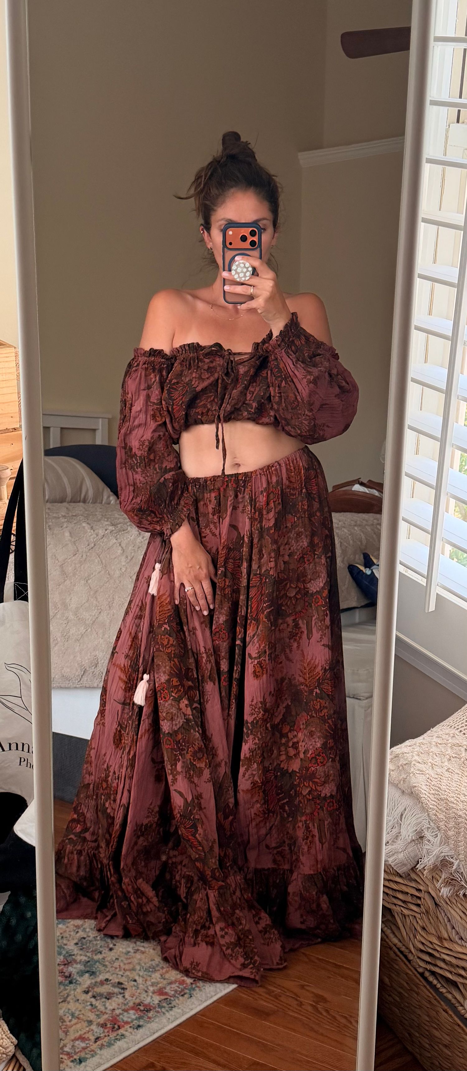 Woman wearing a boho floral rust maxi skirt and matching off-shoulder crop top two-piece set, mirror selfie.