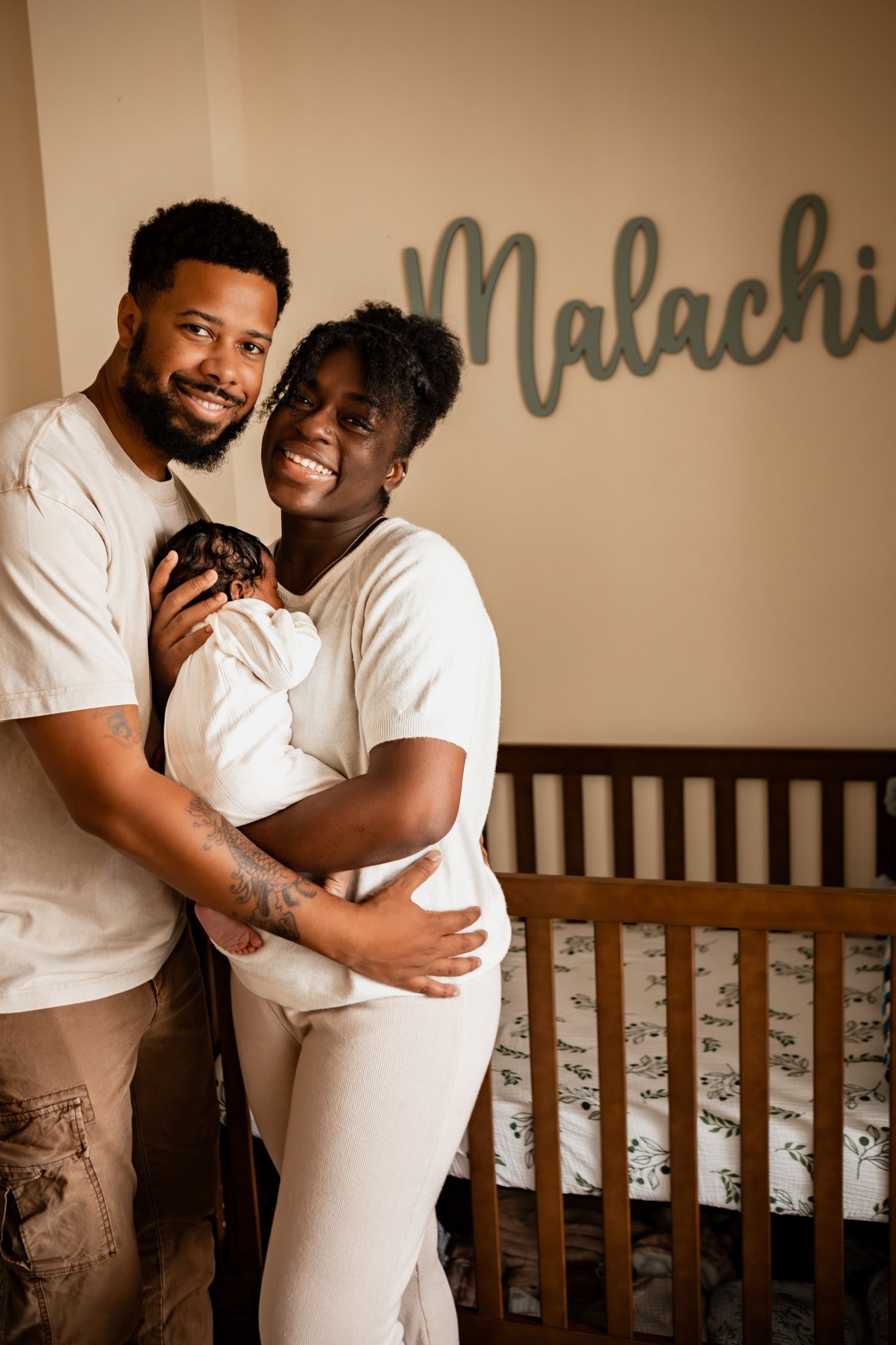 A heartwarming collage shows a tender embrace in front of a wooden crib, creating an intimate moment during a maternity photo shoot.