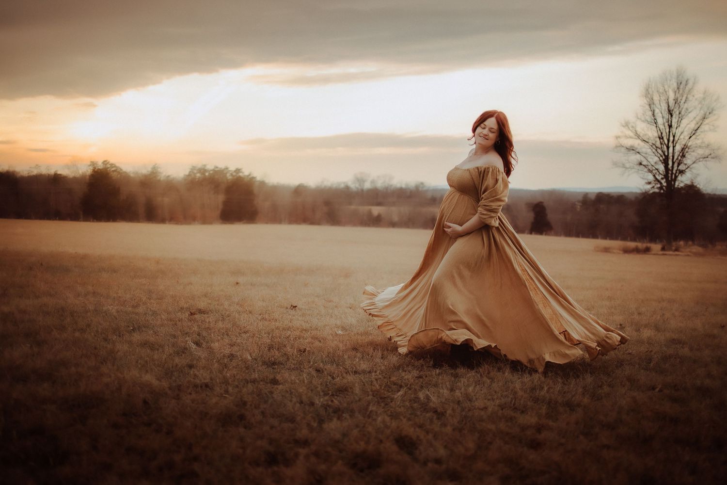 A person in a flowing beige dress twirls in an open field at sunset, creating a dreamy autumn scene.