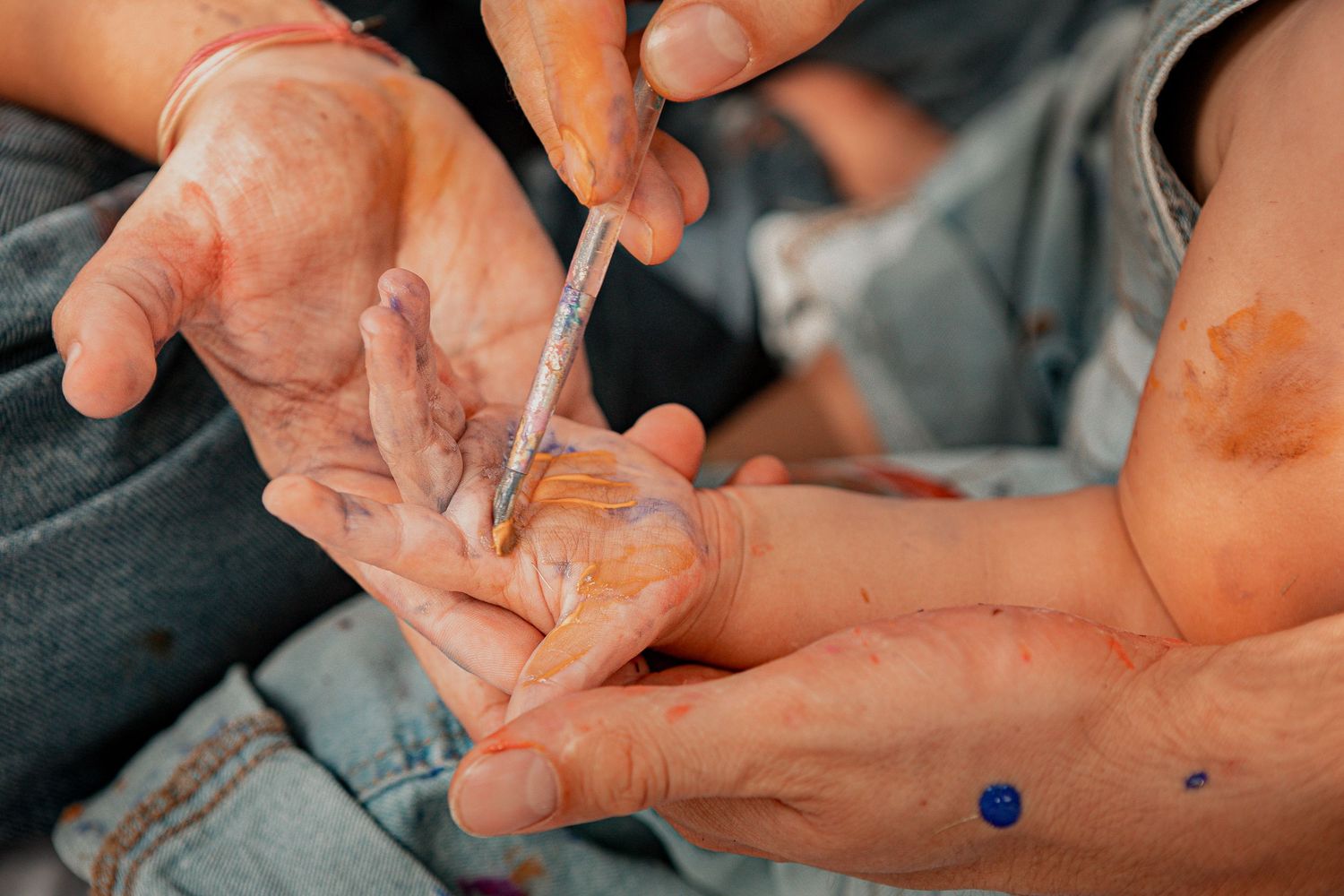 Close-up view of hands preparing drugs with a syringe and small plastic bag.