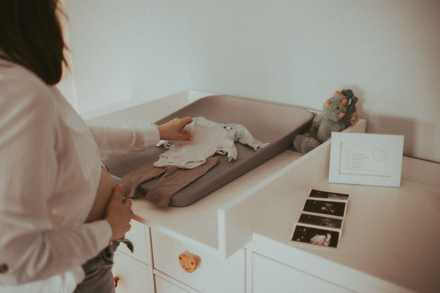 Medical professional in white coat examines patient charts and records at a modern healthcare facility.