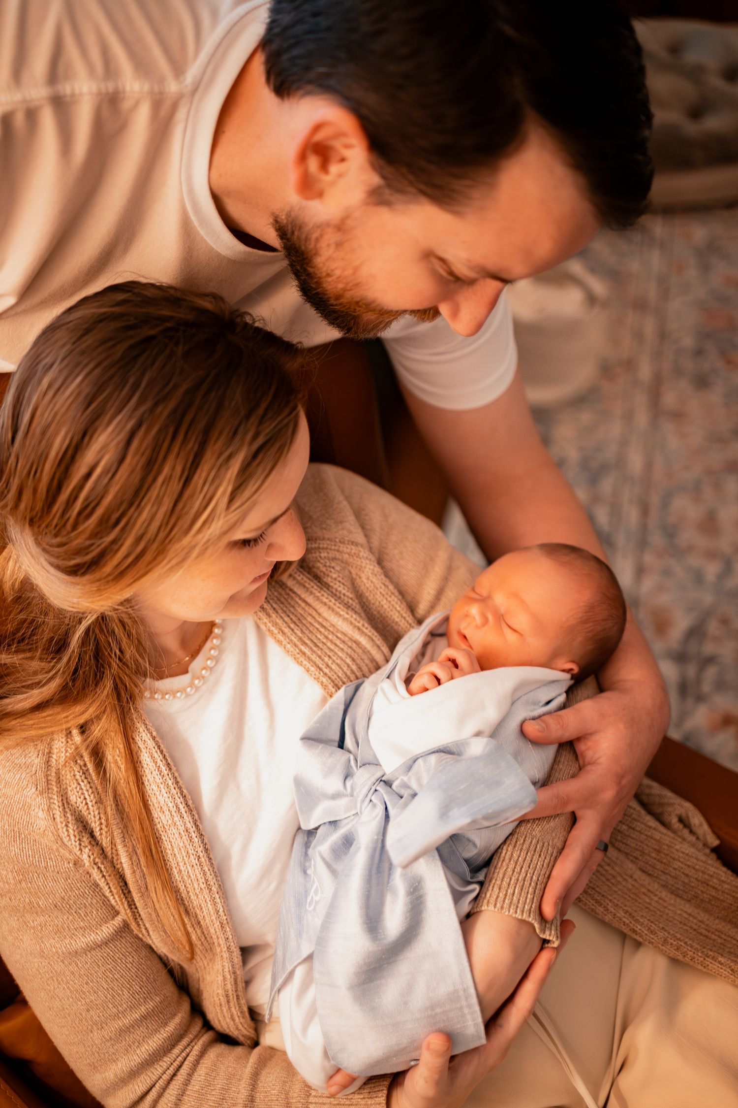 Parents sharing tender moments with their newborn baby in a series of warm, intimate photographs.