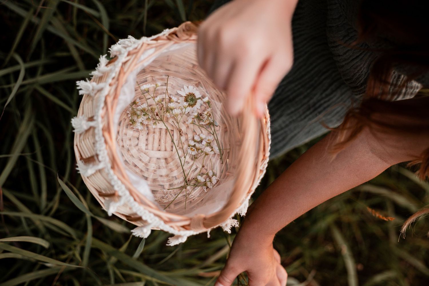 Multiple hands hold decorative coasters or delicate plates with intricate lace-like patterns in pale pink tones.