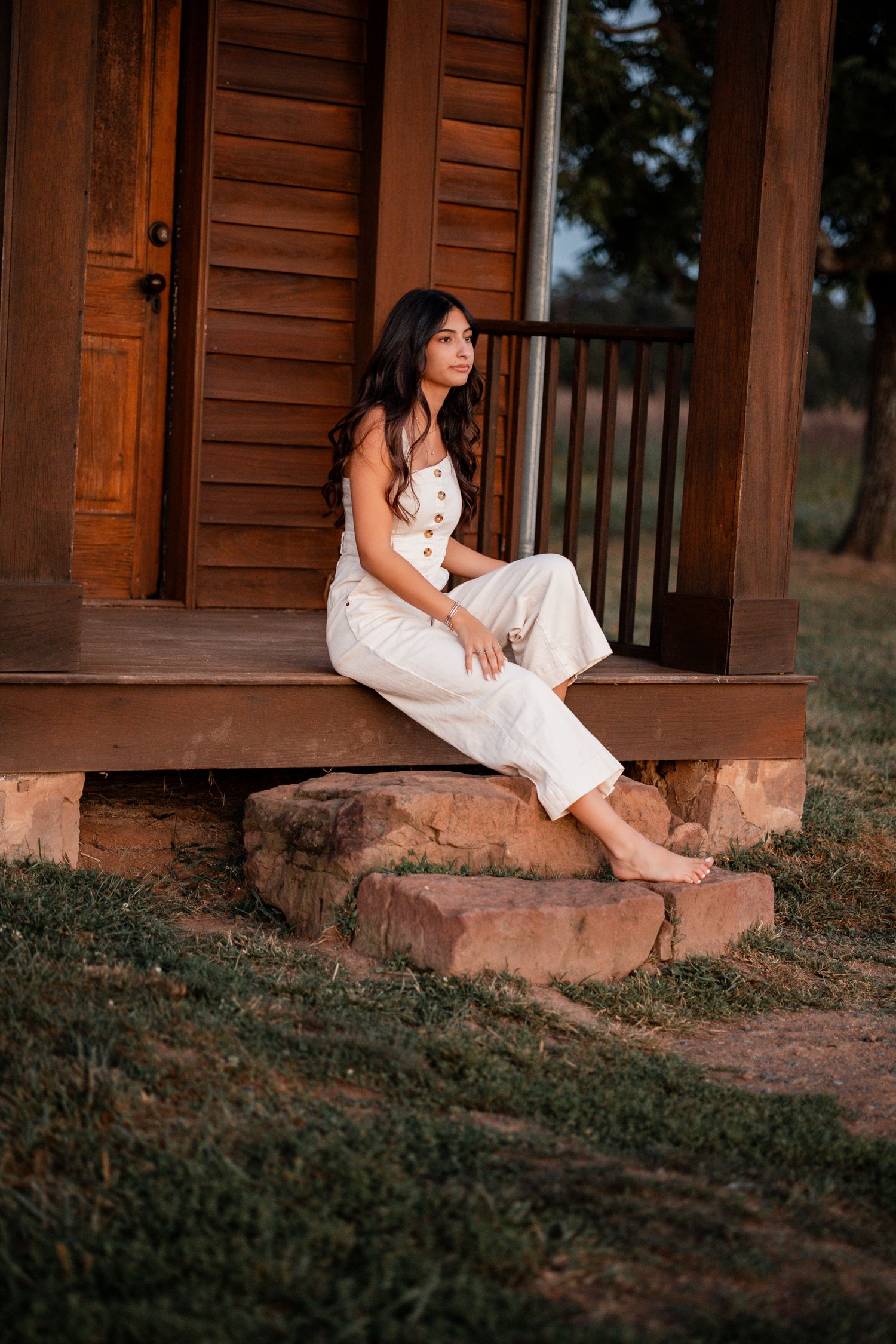 Rustic wooden porch setting with white sundress at dusk.