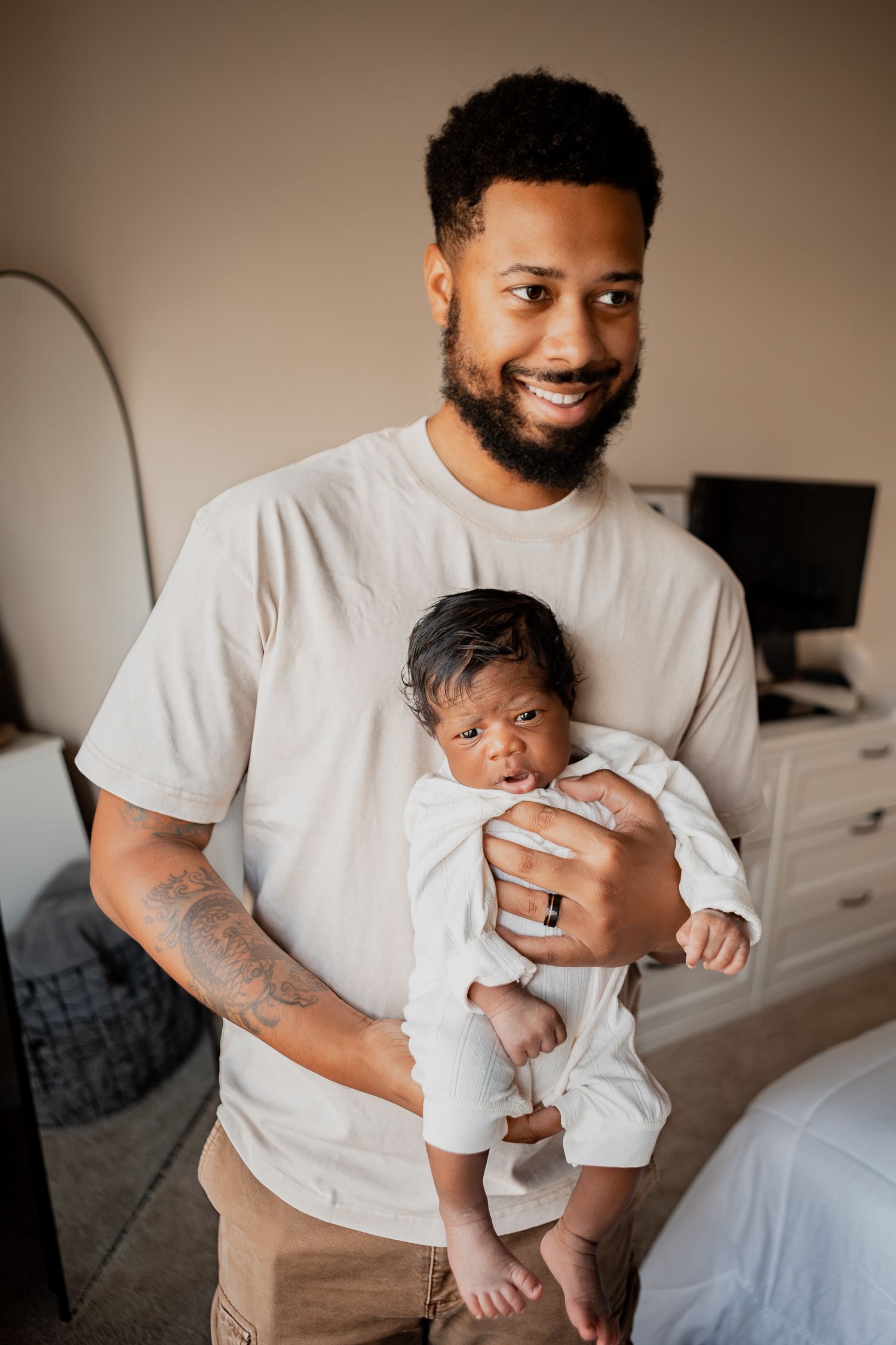 Series of tender moments between parent and newborn baby in white clothing against neutral background.