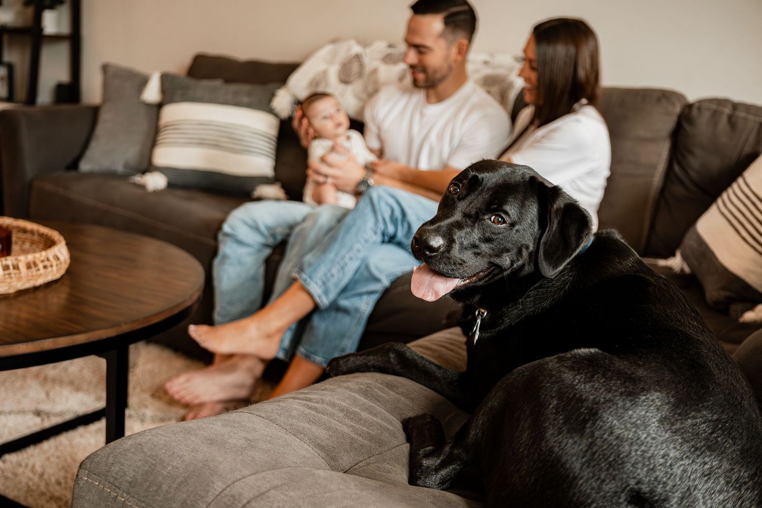 Family spending quality time together watching television on couch in living room.