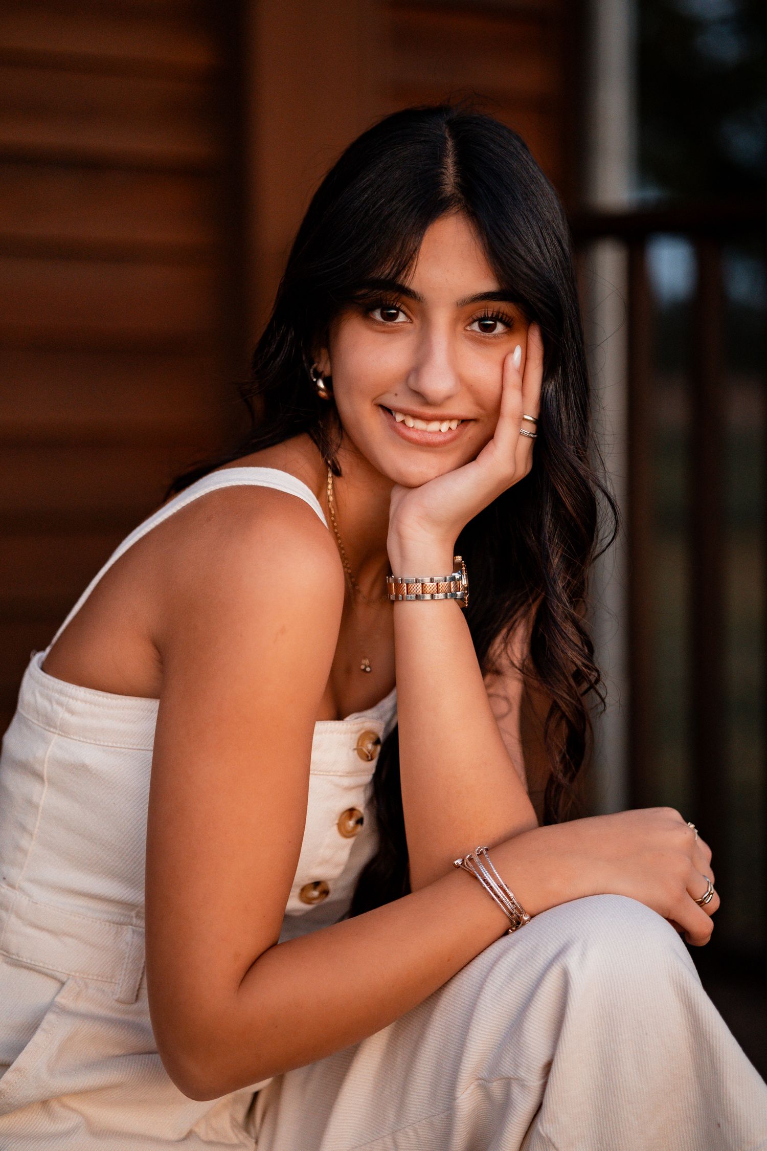 A series of portraits showing someone in a white dress leaning on their hands while sitting outdoors.