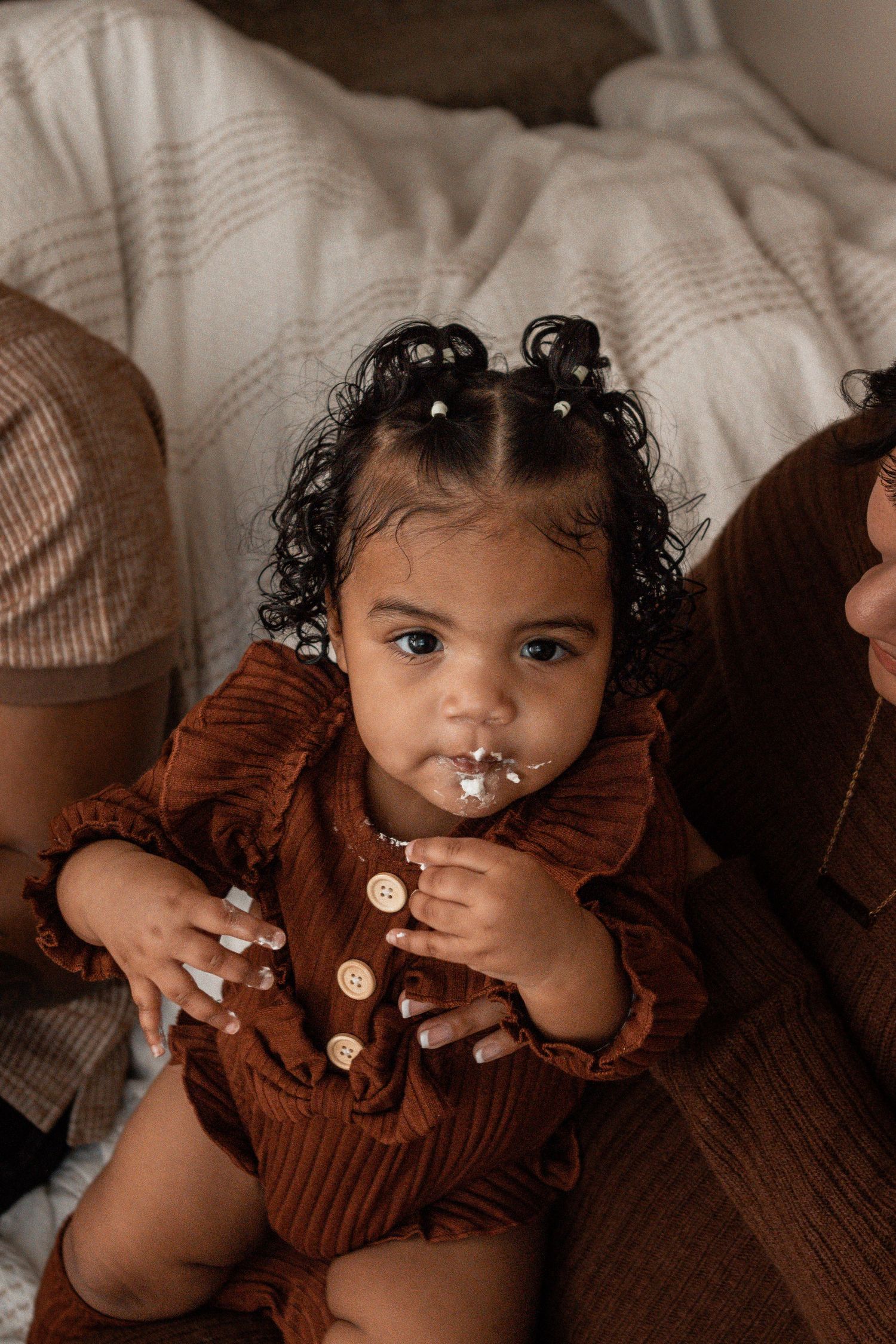 A sequence of images showing a small child in a brown sweater against a light background.