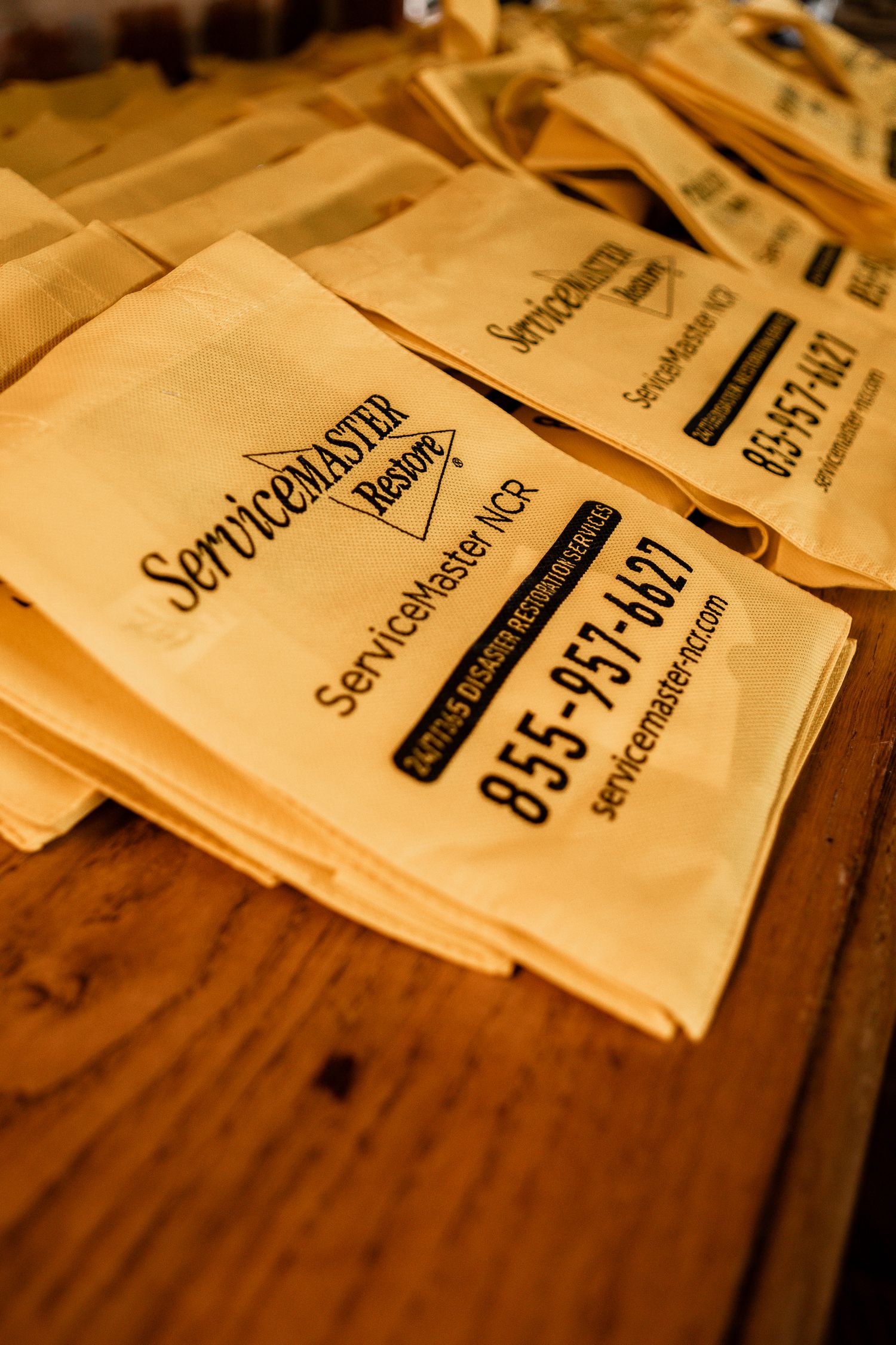 Close-up of paper receipts or documents arranged on a wooden surface in warm lighting.