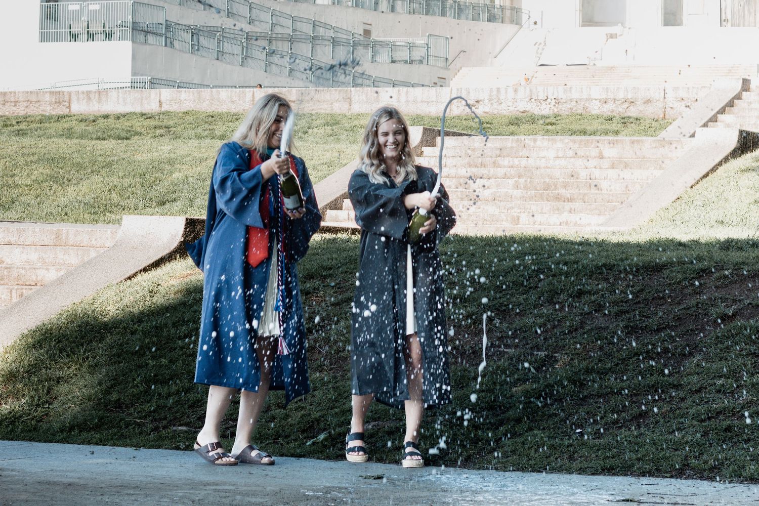 Students bundled in winter coats laugh and play in bubbles blowing across a snowy schoolyard ground.