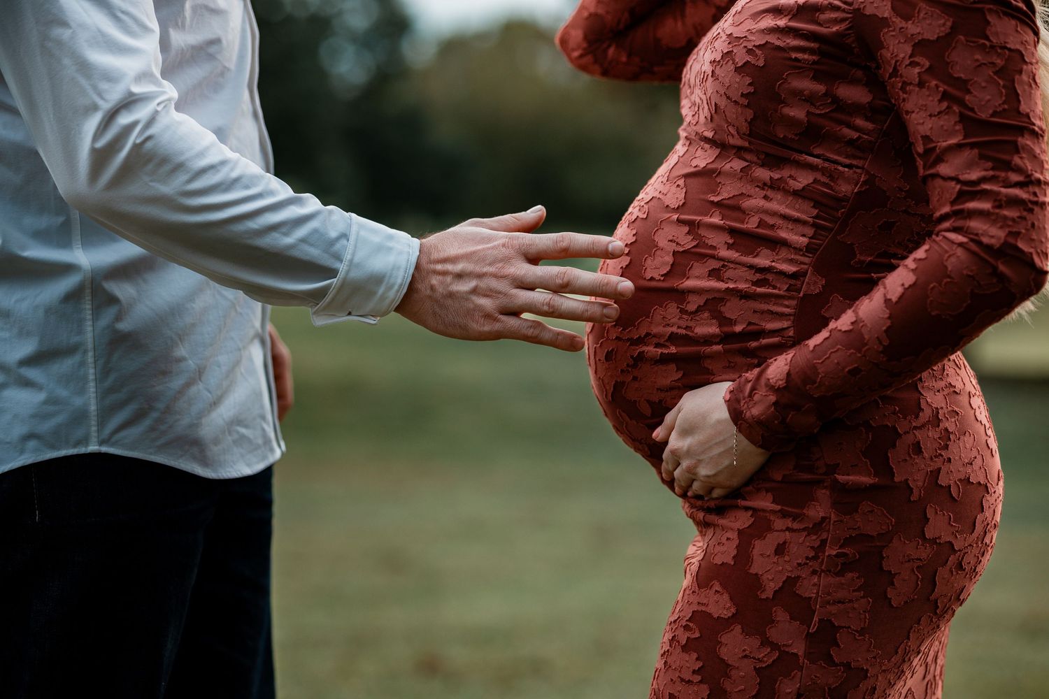 Close-up shots of a couple holding ultrasound photos while standing together outdoors.