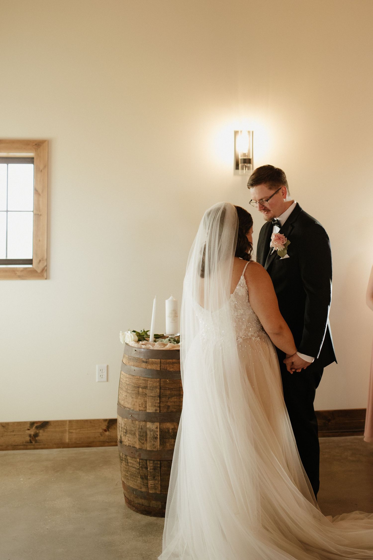 Minimalist indoor wedding photos with rustic barrel decor and natural lighting.