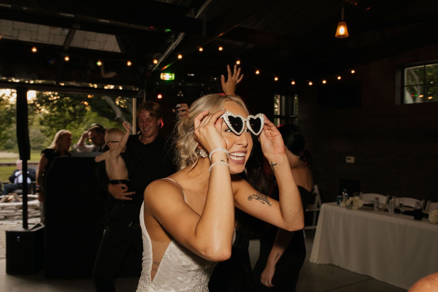 Wedding guests celebrate with sparklers during an evening reception celebration.