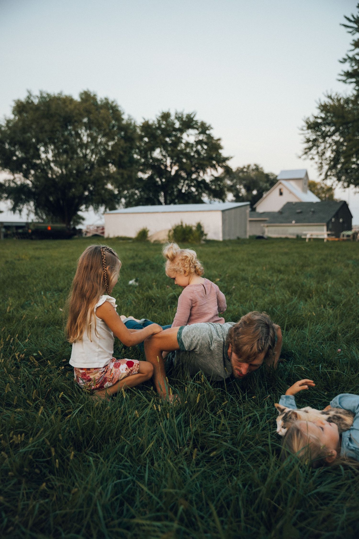 People relaxing together in tall grass on a sunny afternoon.
