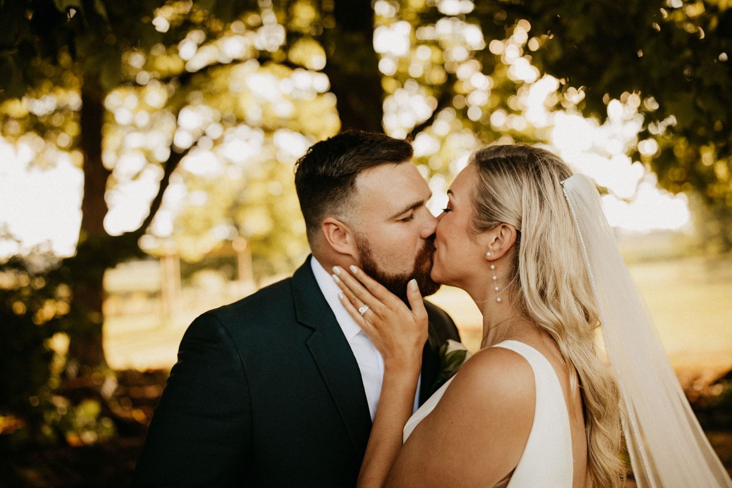 Romantic sunset wedding portraits in a natural outdoor setting.