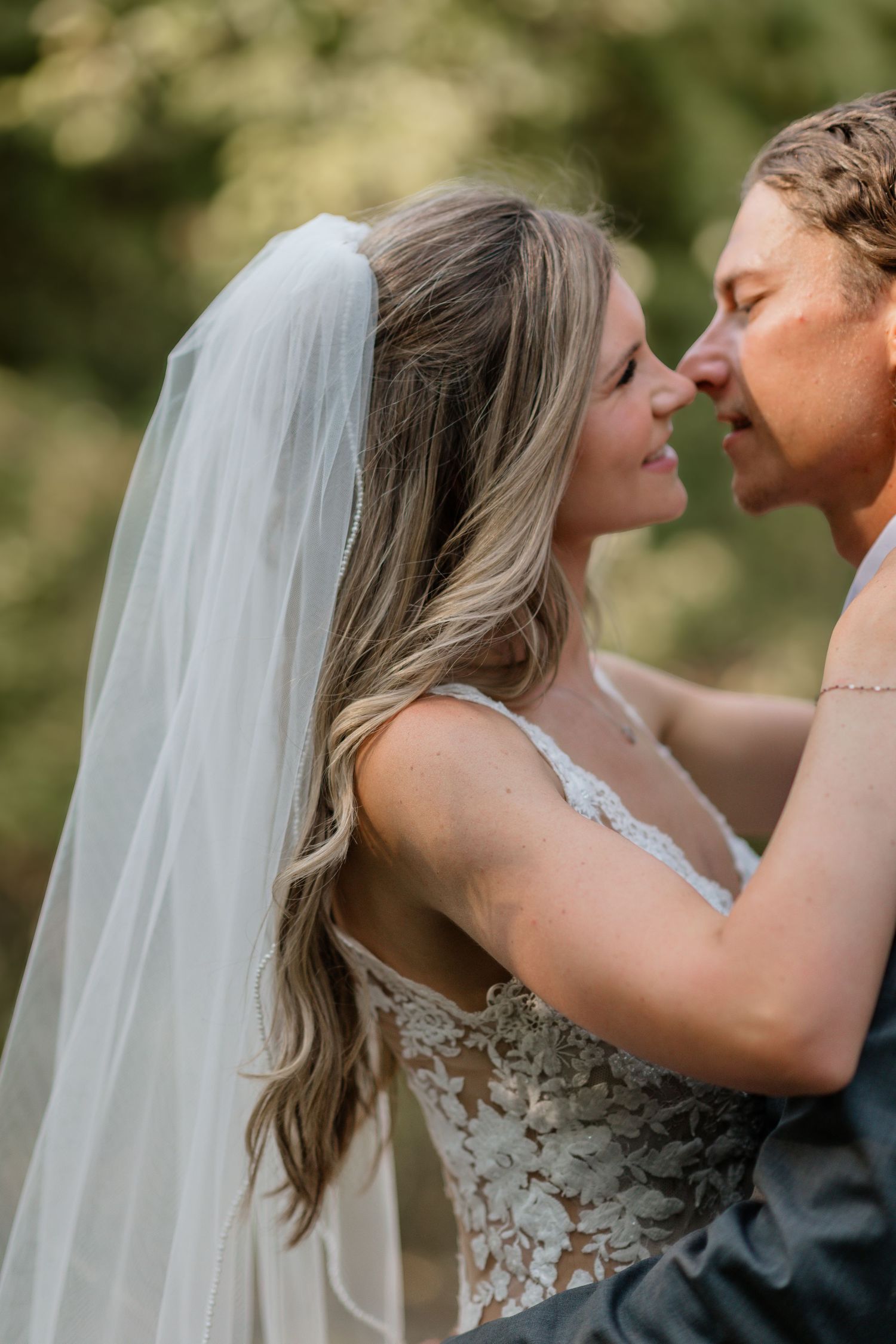 Romantic moment between newlyweds captured in an outdoor setting.