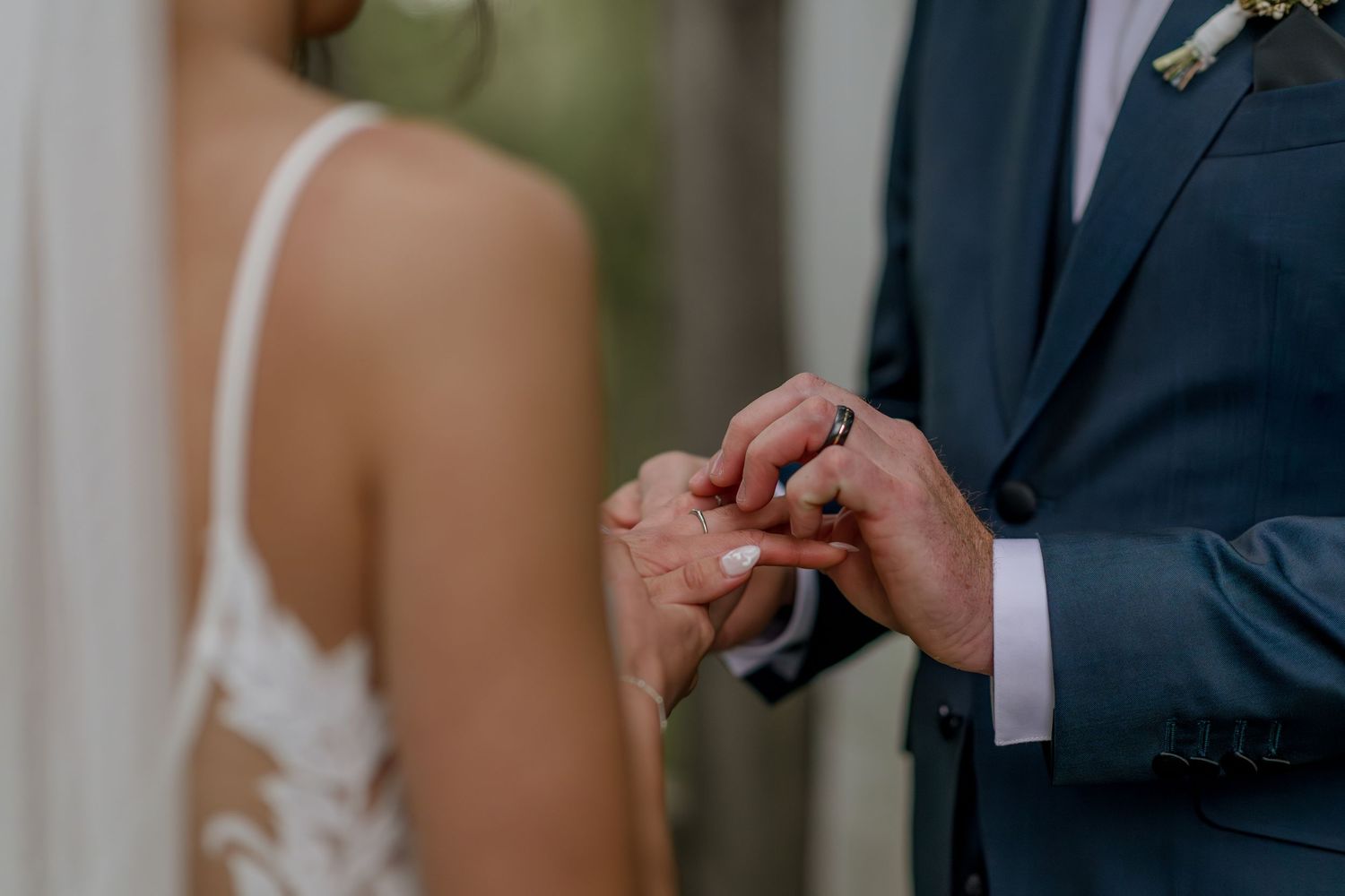 Emotional wedding ceremony moment captured with delicate hand gestures.