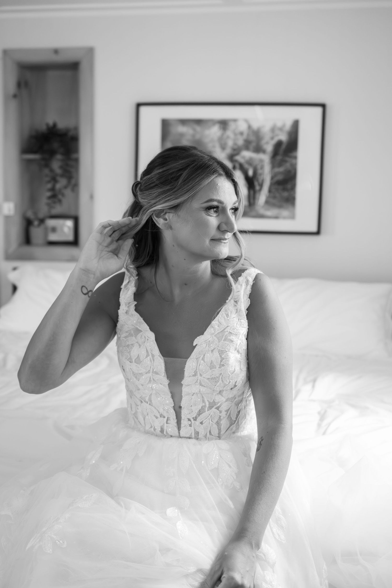Elegant bridal preparation moment showcasing intricate lace details of a wedding dress.