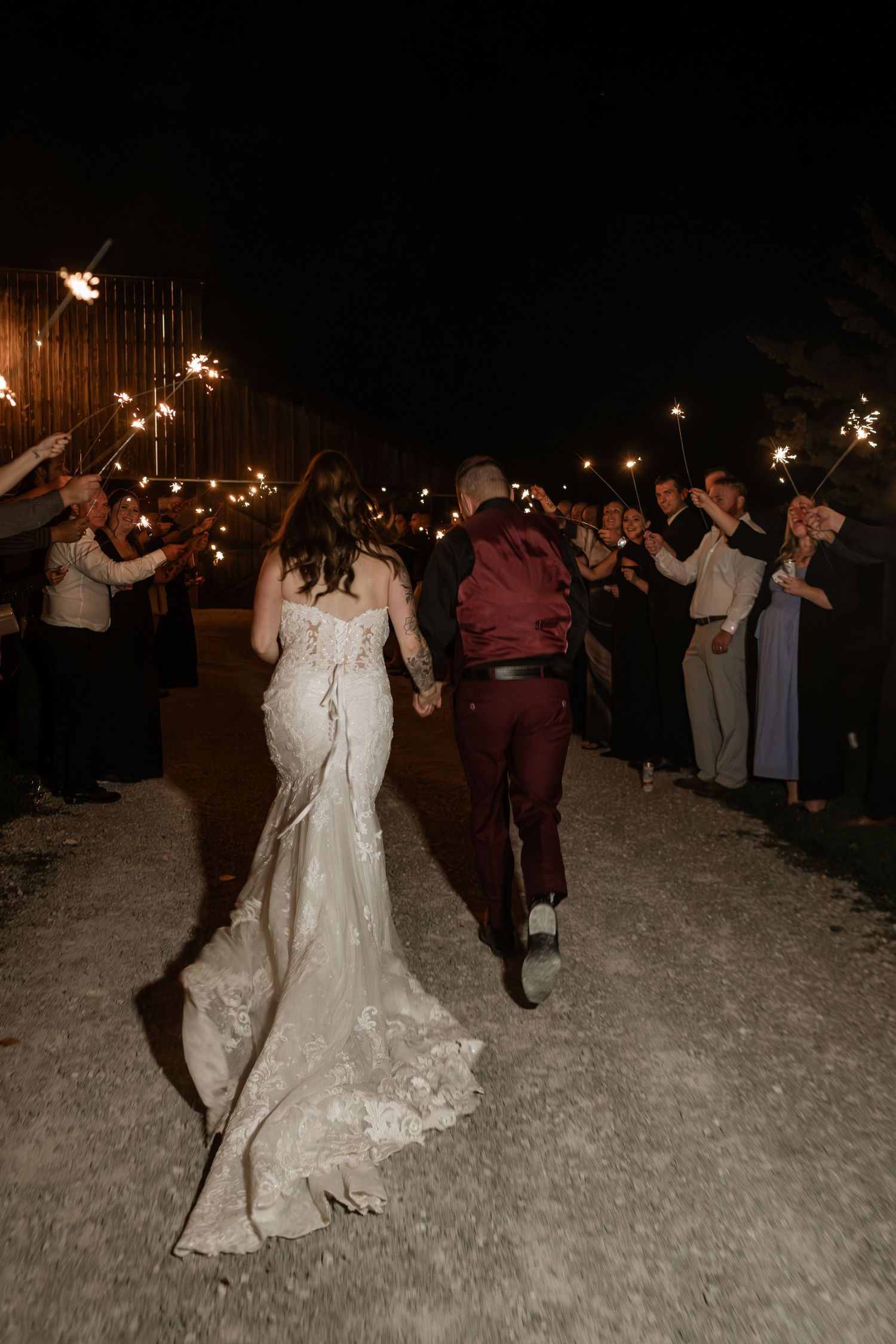 Wedding celebration at night with sparklers creating a magical glowing atmosphere.
